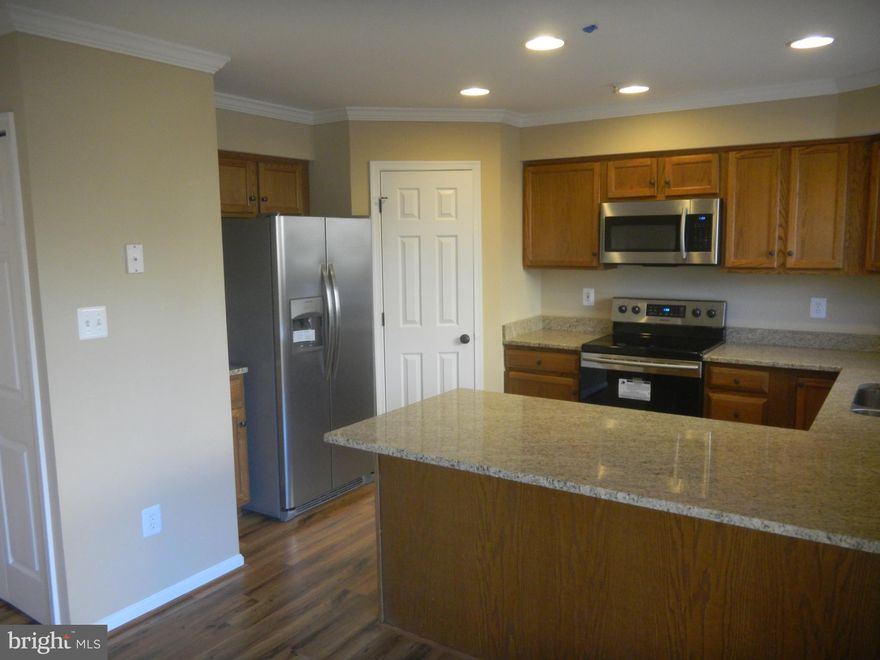 Updated 3 Story with Fresh Paint & Crown Molding... New lighting*** all New Vanities with Granite  and  fixtures*** Granite Counter Tops and Stainless Steel Appliances in Kitchen***Ceramic tile in Baths,  New Carpet and Upgraded Laminate Flooring through out *** Finished Rec Room in Basement with 1/2 Bath.... All new door knobs and hinges ...New Roof and Gutters***Home Warranty by AHS