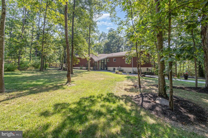 ​Nestled on 11.52 wooded acres just a short drive from historic downtown Gettysburg, this modern 3-bedroom, 2.5-bath home with a 2-car garage offers serene views of the surrounding forest and distant mountains. With over 2,900 square feet, the home features beautiful hardwood floors, a striking glass-front atrium entry, vaulted ceilings, and expansive windows that bring the outdoors in. A spacious 20 x 20 great room includes high ceilings, 15 feet of built-in shelving, a fireplace, and sliding doors to a side deck. The brand new eat-in kitchen flows into a dining room with a second fireplace and vaulted ceilings. The generous primary suite includes two walk-in closets (6 x 5 each) and a luxurious 15 x 12 bath with a jetted tub and walk-in shower. On the lower level, you'll find a cozy carpeted family room with a third fireplace, an oversized storage room, and access to the integral 2-car garage.  The property also features approximately 1.5 acres of fenced area currently being used for cattle. Recent upgrades include a new well, new HVAC, landscaping, sidewalks, gutter guards, and new dog fencing all offering convenience and peace of mind for years to come! Don't miss your opportunity to call this one-of-a-kind property your own. Schedule your private tour today!