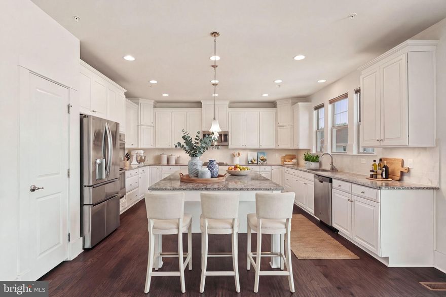 Welcome to 2416 Glouster Pointe Drive in Potomac Shores in Dumfries Virginia, this is a beautifully designed Monroe floor-plan. It is a single-family home offering more than 4,400 finished square feet, three outdoor living spaces, and a finished walkout basement in one of Prince William County’s premier resort-style communities. If you have been searching for a spacious home with  with defined rooms, a chef’s kitchen, a traditional floor plan, generous bedroom sizes, and flexible living space for entertaining, this home checks every box. The heart of the home is the impressive cook’s kitchen, thoughtfully designed for everyday living and gatherings alike. There is a massive center island that  provides seating and workspaces, surrounded by extensive cabinetry and storage. The kitchen opens directly to the great room, keeping everyone connected whether hosting guests or enjoying a quiet evening at home.The main level  features wood floors a  welcoming central foyer that includes a large coat closet, powder room, and a striking craftsman staircase that creates an elegant first impression.Upstairs, the primary suite offers a relaxing retreat with abundant natural light, dual vanities, and a soaking tub,shower and  dual walk-in closets! Three additional spacious bedrooms complete the upper level, including two connected by a convenient buddy bath. An upper-level laundry room adds everyday convenience right where you need it most.The fully finished walkout lower level expands your living space with a large recreation room, separate media room with surround sound, a full bathroom, and a bar area ready for entertaining. French doors and full daylight windows. Outdoor living truly sets this home apart. Enjoy morning coffee on the welcoming front porch, entertain on the rear deck off the kitchen, or relax around the firepit patio accessed from the walkout basement. These three distinct outdoor spaces make the home perfect for year-round enjoyment.Located in the award-winning Potomac Shores community, residents enjoy access to the public Jack Nicklaus Signature Golf Course, The 13,000 sq ft Shores Club featuring the community pools, fitness center, event yard and gathering spaces. There are miles and miles of scenic walking  trails, community gardens, and over 800 acres of preserved green space. Best of all Potomac Shores is a convenient commuter location. It is  approximately 18 miles to Fort Belvoir, approximately 8 to 10 miles to Marine Corps Base Quantico, and just minutes to I-95 via Exit 152 to go North and South and access to Express Lanes and Route 1 as well. Don't let this home slip through your fingers. It is really nice!