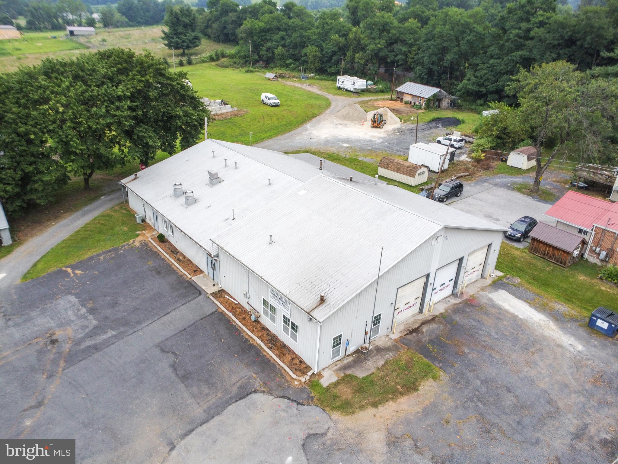 Welcome to 1555 Center Mills Rd – a versatile commercial property offering over 7,500 square feet of usable space on nearly 5 acres in Adams County. Perfectly suited for a variety of business uses, this property is ready for auto-related services, storage, or light industrial operations.
The heart of the property is a 50' x 110' workshop, with 40 feet featuring 14’ ceilings and the remaining 70 feet at 10’ ceilings. It includes 3 oversized 12’ garage doors, a commercial-grade kitchen, LED lighting throughout, men’s and women’s restrooms, and a waiting room/office area, making it ideal for operations that require customer interaction and workspace flexibility.
This property is well-heated with five 100,000 BTU furnaces, three coal stoves, and three Modine-style heaters, offering multiple heating options for different areas or zones.
The 4.78-acre lot provides multiple parking spaces and a driveway leading to the upper portion of the property, which is flat, grassy, and open—excellent for expansion, additional parking, outdoor storage, or display. This space could suit a car lot, repair facility, equipment hub, landscaping operation, or storage unit complex, subject to township approval.
Located in a quiet but accessible area of Aspers, this property offers rural privacy with access to regional markets including York, Gettysburg, and Carlisle.
This space, layout, and land make this a rare find with huge potential!
Buyers should verify permitted uses with the township.