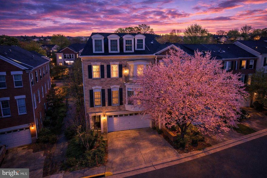 A rare offering in the exclusive McLean Place gated community, this sophisticated end-unit townhome exudes scale, light, and presence. Stately brick architecture, expansive windows, and beautifully proportioned interiors set the tone, while hardwood floors, formal entertaining rooms, a granite-and-stainless gourmet kitchen, and a striking spiral staircase create a sense of timeless luxury. The bedroom suites are generously sized with private bathrooms, while the primary suite offers a retreat from the hustle and bustle of Tyson's Corner, America's Next Great City. The bright above-grade lower level expands the home’s versatility for guests, work, or recreation, complete with wiring for a surround sound theater and a natural gas fireplace. A whole-house speaker system enhances the living experience throughout, and the two-car garage is equipped with an EV charging outlet. With over 3,400 square feet and an unbeatable location near Metro and key commuter routes, this is an exceptional opportunity to own a home of substance and style in one of McLean’s most sought-after enclaves.