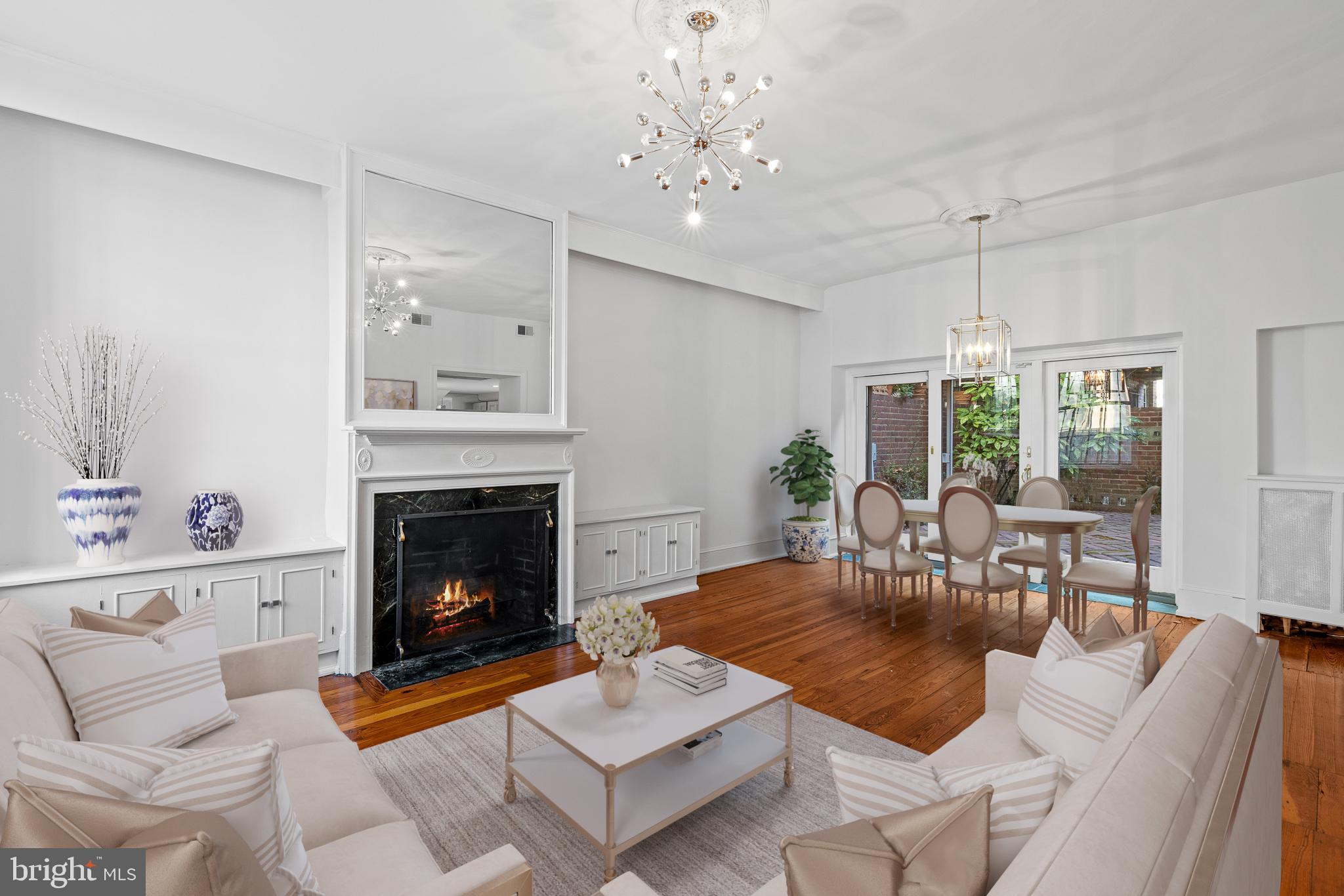 Tucked away on a serene and private street in Rittenhouse Square, this unique double-wide, two-story townhouse offers a perfect alternative to condo living. With an impressive 31-foot width, the home features an expansive open layout. The living and dining areas are adorned with floor-to-ceiling sliding glass doors that lead to a double-wide backyard oasis, flooding the home with natural light and offering picturesque garden views. The enclosed herringbone brick patio, surrounded by mature landscaping, provides a tranquil and private retreat. Inside, original pine floors are beautifully complemented by modern oak accents. The chef’s kitchen seamlessly connects to a cozy breakfast nook, ideal for morning coffee. The upper level hosts a primary suite with generous closet space, and a second spacious bedroom. The semi-finished lower level adds versatility with a bonus room and an additional powder room. All of this is just moments away from Rittenhouse Square’s vibrant dining, boutique shopping, and cultural attractions, as well as minutes from the Schuylkill Trail and dog park. Experience privacy, tranquility, and a prime location.