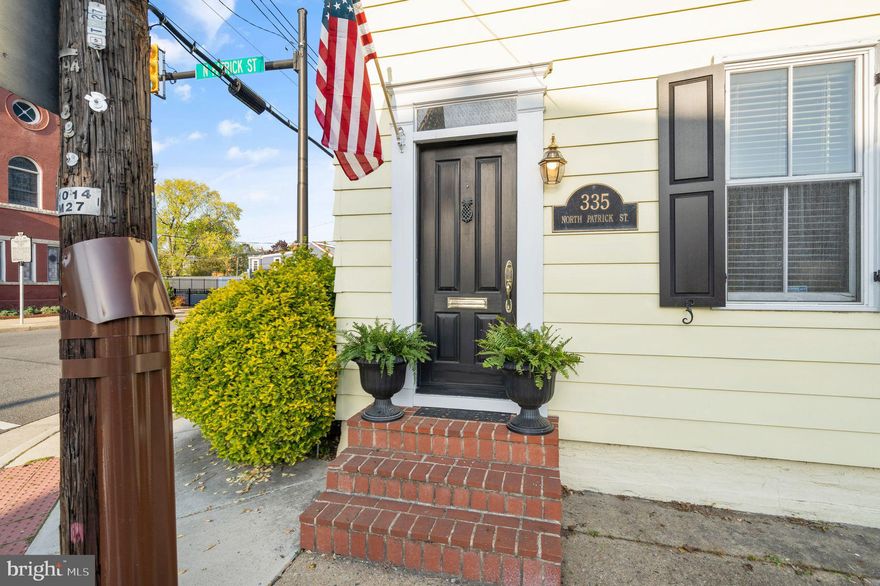 Welcome to 335 N Patrick Street in the heart of Old Town Alexandria, only two blocks from King Street! An updated 1900s end unit row house is available in a prime location! This stunning home pairs historic charm and modern conveniences. Exquisite curb appeal with all-new exterior paint with a charming white picket fence that frames the lush landscaping that spans the entire length of the side of the property: a growing peach tree, two crepe myrtles, and other established bushes can be found there! Once inside, you will find refinished hardwood flooring throughout! The first floor offers a generously sized living room with a gas fireplace, a spacious dining room, laundry, and an updated kitchen.  Off the kitchen, you will step out to your dream patio and lush backyard! It's the perfect retreat for relaxing and enjoying your summer days! The fully fenced yard is ideal for pets and also offers great privacy. On the upper level, there are two large bedrooms with two updated full baths. The primary bedroom features skylights and a walk-in closet. Use the large attic for storage or convert it for additional living space!  Newer HVAC {2018}, Stainless Steel Appliances, Granite Countertops! Centrally located to everything-  .9 miles to the King Street metro, 4.6 miles to the Reagan International Airport, .8 miles to Waterfront Park, .8 miles to Whole Foods. This wonderful gem presents the rare opportunity to enjoy a residence that enables a vibrant lifestyle within minutes of the multiple amenities that Old Town Alexandria has to offer.