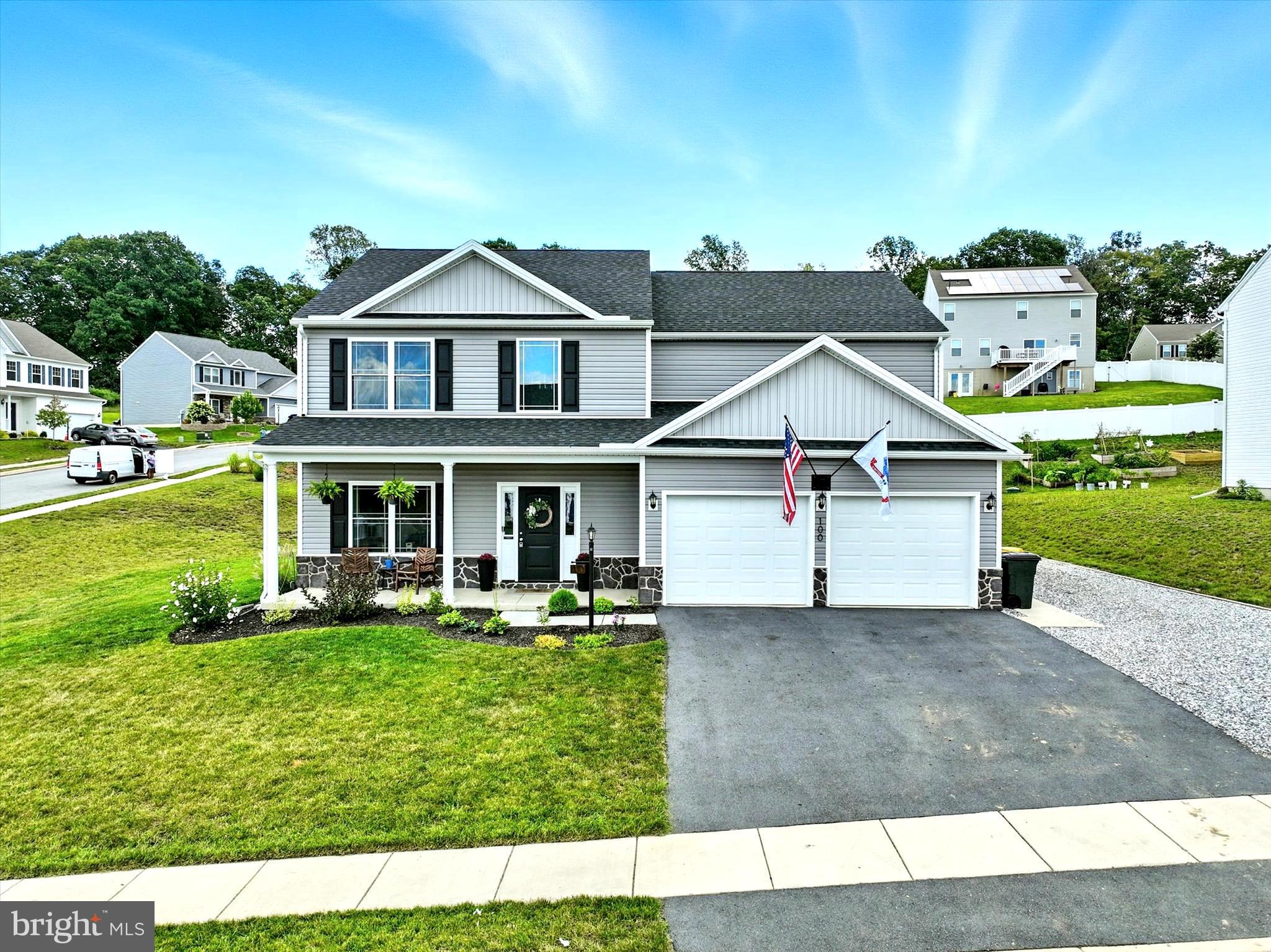 Welcome to 100 Steeple Chase Drive – a residence that feels brand new, without the wait of building or today’s rising construction costs. Nestled in the sought-after Lexington Estates community within Northeastern School District, this home offers the perfect balance of tranquility and convenience—surrounded by picturesque countryside yet just minutes from shopping, dining, I-83, Route 30, and the PA Turnpike for effortless commuting. From the moment you arrive, you’ll be captivated by the manicured landscaping and exceptional curb appeal. A thoughtfully designed stone side parking area provides the ideal space for a camper, boat, or work trailer, while the welcoming front porch and charming rear patio set the stage for morning coffee, evening relaxation, or hosting friends under the open sky.
Step inside and you’ll immediately feel the warmth of a home that is larger than most in the neighborhood and bathed in natural light. The open-concept design flows beautifully, beginning with a versatile front room—perfect as a formal living space, dining room, or stylish home office—paired with a convenient half bath nearby. At the heart of the home, the gourmet kitchen impresses with upgraded counters, stainless steel appliances, and abundant cabinetry. The expansive island serves as both a culinary centerpiece and a gathering spot—perfect for meal prep, casual dining, or savoring a glass of wine with friends. Whether you’re a dedicated chef or simply love to entertain, this space is designed to inspire. The kitchen opens seamlessly to the dining area and elegant family room, where a cozy fireplace framed by custom built-ins creates a sophisticated yet inviting ambiance. Sliding glass doors extend the living space outdoors, making it ideal for summer cookouts and holiday celebrations alike. Upstairs, you’ll find four spacious bedrooms, two full baths, and a convenient laundry room. The primary suite is a luxurious retreat, offering a spa-inspired en-suite with dual vanities, a sleek walk-in shower, and a generous custom-built walk-in closet. Every detail is designed to provide comfort and serenity. Below, the basement with superior concrete walls offers remarkable durability and an expansive footprint, presenting endless opportunities for future finishing—whether it’s a home theater, fitness studio, or game room.
This property has been lovingly maintained by a proud military family, who poured care and upgrades into every detail. Parting is bittersweet, but the call of duty leads them on. Their dedication to this home is evident throughout, making it a truly special opportunity for the next owners.
Meticulously cared for and move-in ready, this home embodies quality, elegance, and modern comfort in one of the area’s most desirable neighborhoods. Don’t miss the opportunity to call this exceptional property your own.