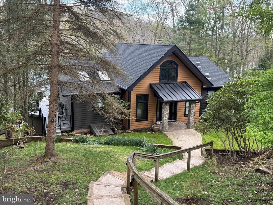 Welcome to “All Decked Out”—a stunning lakefront retreat offering the perfect blend of privacy, space, and year-round adventure in the heart of Deep Creek Lake. Nestled on a beautifully wooded 1.3-acre lot along Marsh Hill Road, this 5-bedroom, 4-bath home boasts approximately 150 feet of private lake frontage and delivers the ultimate waterfront lifestyle.
Designed for both relaxation and entertaining, the home features expansive multi-level decking that captures serene lake views from nearly every angle. Enjoy evenings soaking in the hot tub, gathering around the lakeside fire pit, or dining outdoors while overlooking the water. A private path leads directly to the lake and a double-slip dock, making boating and water activities effortless.
Inside, the thoughtfully curated interior offers a warm and inviting atmosphere with spacious living areas, an open-concept kitchen and dining space, and a large main living room filled with natural light and picturesque lake views. The lower-level recreation room provides additional space for entertaining, perfect for game nights, movies, or hosting larger groups. 
The home comfortably accommodates family and guests with multiple bedroom configurations, including two king suites with private baths. Whether you’re looking for a full-time residence, second home, or investment property, this home is ideally suited for all.
Located just minutes from Wisp Resort, Lodestone Golf Course, restaurants, and area attractions, this property offers both tranquility and convenience in one of Deep Creek Lake’s most desirable locations. 
Turnkey, lakefront living at its finest—this is Deep Creek Lake living, All Decked Out.