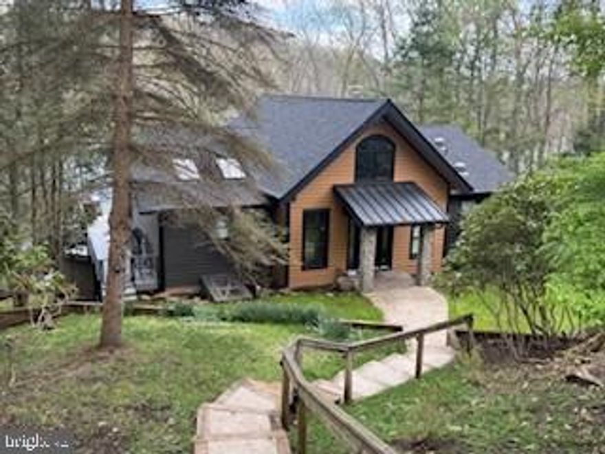 Welcome to “All Decked Out”—a stunning lakefront retreat offering the perfect blend of privacy, space, and year-round adventure in the heart of Deep Creek Lake. Nestled on a beautifully wooded 1.3-acre lot along Marsh Hill Road, this 5-bedroom, 4-bath home boasts approximately 150 feet of private lake frontage and delivers the ultimate waterfront lifestyle.
Designed for both relaxation and entertaining, the home features expansive multi-level decking that captures serene lake views from nearly every angle. Enjoy evenings soaking in the hot tub, gathering around the lakeside fire pit, or dining outdoors while overlooking the water. A private path leads directly to the lake and a double-slip dock, making boating and water activities effortless.
Inside, the thoughtfully curated interior offers a warm and inviting atmosphere with spacious living areas, an open-concept kitchen and dining space, and a large main living room filled with natural light and picturesque lake views. The lower-level recreation room provides additional space for entertaining, perfect for game nights, movies, or hosting larger groups. 
The home comfortably accommodates family and guests with multiple bedroom configurations, including two king suites with private baths. Whether you’re looking for a full-time residence, second home, or investment property, this home is ideally suited for all.
Located just minutes from Wisp Resort, Lodestone Golf Course, restaurants, and area attractions, this property offers both tranquility and convenience in one of Deep Creek Lake’s most desirable locations. 
Turnkey, lakefront living at its finest—this is Deep Creek Lake living, All Decked Out.