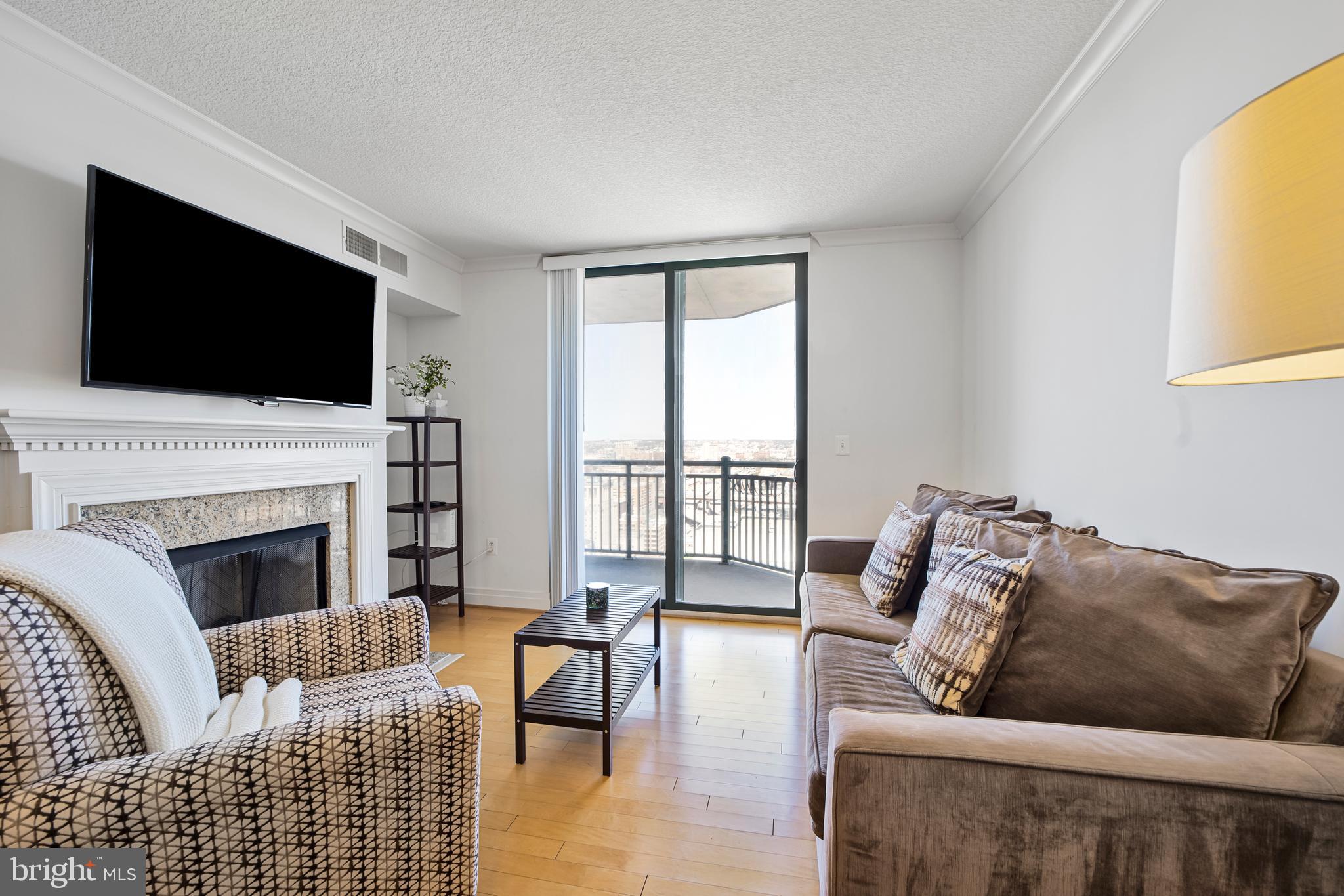 Stunning 2-bed, 2-bath condo on the 26th floor of the sought-after 414 Water St. building offers an exceptional living experience just blocks from the Inner Harbor. Step inside to a bright and airy open floor plan, where gleaming hardwood floors and abundant natural light create an inviting atmosphere throughout. The large kitchen boasts ample cabinetry, sparkling granite, a two-tier island with breakfast bar, and stainless steel appliances! The adjacent dining area flows seamlessly into the living room, where a cozy gas fireplace sets the perfect ambiance for relaxing or entertaining. Two spacious bedrooms offer generous closet space and en-suite bathrooms for ultimate comfort. A convenient in-unit laundry closet adds to the ease of everyday living. Step onto your private balcony to take in breathtaking city views, an ideal spot to savor your morning coffee or unwind in the evening. This pet-friendly building boasts an array of amenities, including a 24-hour concierge, outdoor pool, fitness center, business center, and resident lounge. For added convenience, an assigned parking space (with a monthly fee) and a secure 3’x5’ storage unit are included. The seller is open to selling the furnished unit if there is interest. Take advantage of the prime location just a few blocks to Shot Tower Metro, Whole Foods and Downtown Baltimore's best attractions, including M&T Bank Stadium, Oriole Park, the National Aquarium, BWI, and more! Don’t miss this!
