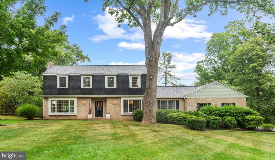 Desirable Woodmark neighborhood with an oversized, stunning lot. You will love sitting outside in this idyllic setting with a country feel, yet still located in a central location. Bright and sun filled with windows galore. Main level features a custom double entry door, all hardwood flooring, a gorgeously updated kitchen with Quartz countertops, induction cooktop, double ovens and custom drawers and cabinets.  Formal dining room with custom wainscotting, bay window and corner cabinet. Relax in the reading room/den with a cozy woodburning fireplace and French doors. Upper level Primary Bedroom suite includes a large walk-in closet and recently renovated bathroom.  3 other spacious bedrooms and full bathroom complete the upper level. Finished lower level provides extra entertaining space. Private, expansive lot featuring mature landscaping and trees, blooming flowers and bushes in the Spring, storage shed, invisible fence and fantastic patio. Most of the home has been updated in the past 10 years, including kitchen, bathrooms, flooring, paint and shed. In the past 5 years - new roof and flashing, septic field, well pump, well water softener and neutralizer, primary bathroom and water heater. Basement waterproofed in 2016. This is a very special home that you will not want to miss!