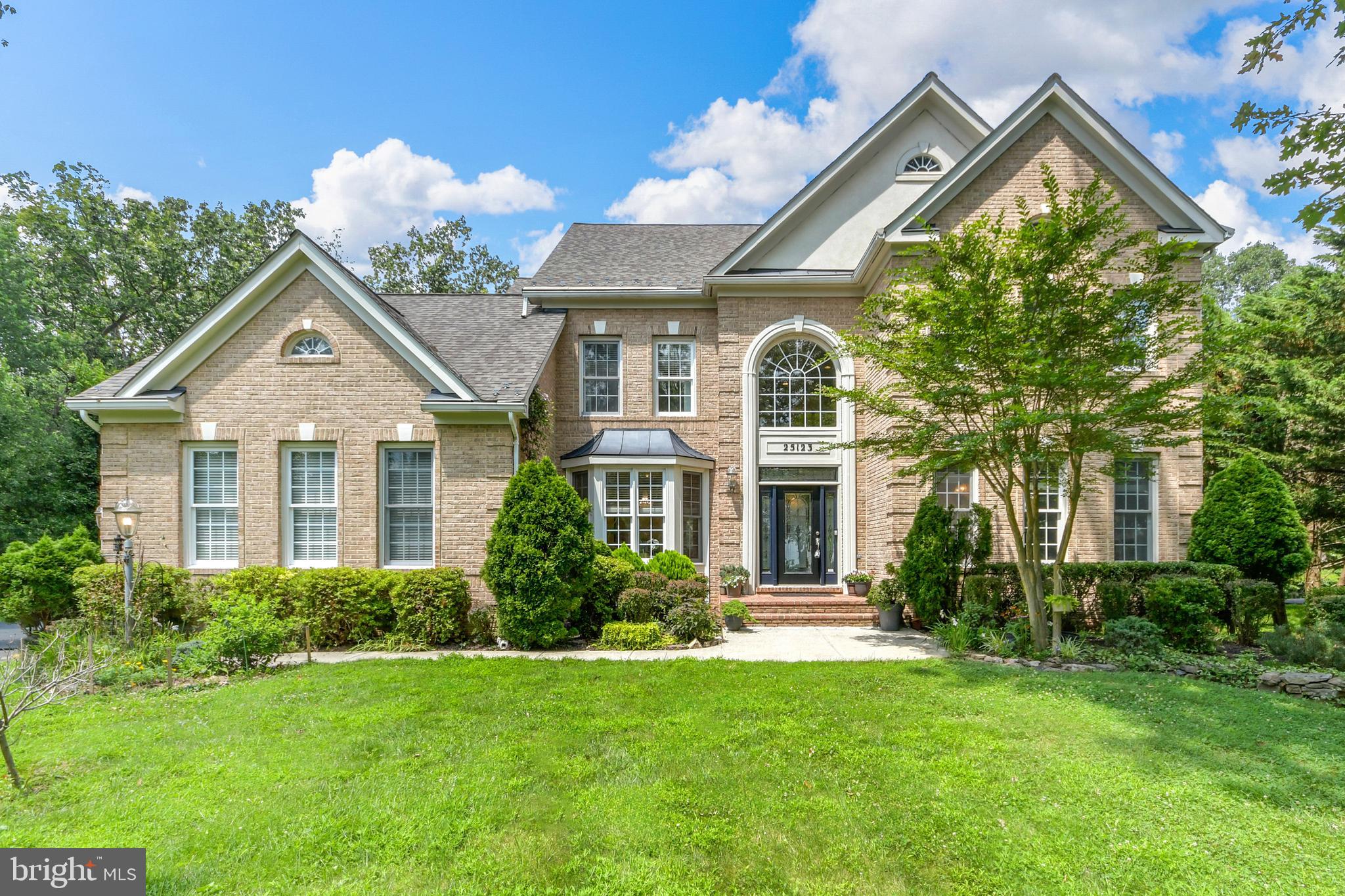 Nestled among the trees at 25123 Vista Ridge Road in Laytonsville, Maryland, this beautifully appointed home is a true masterpiece, offering an impressive 4-6 bedrooms and 3.5 baths. The open floor plan boasts extended-height ceilings, accentuated by the rich gleam of hardwood floors that flow throughout the main level.As you enter the bright two-story foyer, you’ll be welcomed by a front-to-back cascade stairway adorned with custom-crafted circle-themed railings. The first floor is inviting and open, seamlessly transitioning from the gourmet kitchen to the great room, where exceptional natural light pours in through floor-to-ceiling windows, highlighting the lush views of the expansive backyard. The primary suite is nothing short of amazing, featuring a two-sided gas fireplace that adds warmth and ambiance, along with a luxurious primary bath that is a true retreat. Here, you'll find stunning chrome Italian sculptural fixtures, wave-like tiling, and a German-made corner glass shower, creating a spa-like experience at home. The large bedrooms, each designed for comfort and tranquility are perfect for family and guests. The finished walkout basement spans the entire footprint of the home, featuring full-sized windows and two sets of French doors, making it an entertainer’s dream or an ideal in-law suite with a private entrance. The separate workshop will entice even the most discerning hobbyist, while additional bonus rooms offer the potential for a future theater room or music/art studio. Adding to the home's appeal is the three-car side-load garage, providing ample space for vehicles and storage. The secluded and private backyard serves as a tranquil oasis, perfect for peaceful relaxation and serene outdoor exploration, with wooded areas ideal for hiking. Located on a cul-de-sac in the highly sought-after neighborhood of Seneca Springs, this home is filled with unique features and artistic touches that truly make it a remarkable property, inviting you to experience beauty and comfort every day. Additional highlights include energy-efficient features, proximity to local amenities, and a welcoming community atmosphere, making this home not just a residence, but a lifestyle choice. Whether you’re entertaining guests or enjoying quiet evenings, this home offers the perfect blend of elegance and functionality.