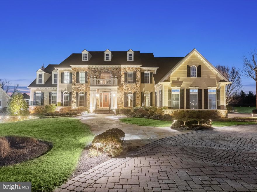 Sited on nearly nine acres in the heart of Clarksville, with acquired Preserve land, this property is one of a kind and a very rare opportunity.  Built by NV Homes, this Monticello has options and amenities at every turn.  Inside, a two-story foyer is defined by a pair of curved staircases that cascade around the marble floor, medallion and tray ceiling. The foyer is sided by living and dining formals and the extended foyer is defined by four classical columns that announce arrival into the heart of the home. On an axis with the foyer, a wall of windows and transoms stream light into a spacious Family Room where family and friends can gather under a dramatic coffered ceiling to enjoy the fireplace and media built-ins. 

The thoughtful floor plan circles from the Family Room around a private secondary stair to the Kitchen and Breakfast Room with atrium doors leading to an outdoor covered pavilion, dining deck and gazebo. The gourmet kitchen has a commanding center island, Viking appliances, and a sizable walk-in pantry outfitted with an elaborate organizer system.   The morning room in the round is bathed in the light from windows on three sides and has a breakfast bar with an observation opening into the kitchen, while the breakfast room shares a planning hutch and a butler’s service pantry.  The main level extends to include a study with built-in library shelving and a quintessential Monticello conservatory on one wing, and an oversized laundry center, planning desk, arrival center with built in cubbies, garage access door and a secondary entrance door near the exterior electric car charging station and extra car park area. 

Upstairs, six en-suite bedrooms and five full baths encircle the open upper landing and terminate at the primary suite that is announced with French doors that open first into a gracious sitting room with lighted built-ins and a beverage fridge. The primary bedroom follows form with a dramatic tray ceiling with cove lighting, and a second built-in wall of millwork for mounted media, book shelving, and cabinetry storage. Downstairs, a full daylight basement is above grade in the rear of the home and offers robust indoor entertainment venues including a wet bar, full back bar with dishwasher and beverage fridge, billiards area, game area, recreation, ensuite bedroom, exercise room and theater riser and race car simulator.  

Outside, a professional Landscape Architect created a resort-like setting with outdoor living, dining and entertaining spaces and a spectacular lighting design.  The design plan begins on the paver driveway and the meandering front walk, to the stone garden beds that wrap the foundation plantings. The lower level continues the design with an expansive stone patio, bordered by pavers and plantings that follow the overall form and design. A covered patio protects an outdoor kitchen and bar, while an outdoor fireplace is artfully enhanced with a pergola.  The upper covered deck is richly crafted with Epi wood that extends in two directions to include a sitting area on one side and a gazebo on the other side.  Lovers of outdoor living will thrive in this setting, where they can enjoy endless options for living, dining and entertaining including music from outdoor speakers, dramatic landscape lighting for starry nights, and heaters to extend the season.  Come home and embrace every moment of a very special lifestyle with nearly 10,000 square feet of living space, overlooking nearly nine acres of Preserved land right in your backyard.