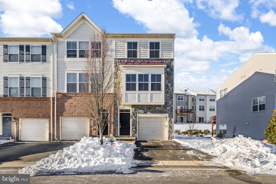 This modern end-unit townhome in Stafford delivers a low-maintenance lifestyle with thoughtful upgrades, flexible living space and one of the more commuter-friendly locations in the region. Introducing 400 Woodstream Circle!  This three-level residence combines everyday practicality with polished finishes and a layout that lives larger than its footprint. Built in 2014, the home spans roughly 1,900 square feet with two bedrooms, two and a half bathrooms and a single-car garage, plus an additional two car concrete driveway and ample guest parking throughout the community. Its end-unit position adds extra windows, natural light and a sense of separation that’s hard to come by in townhome living anywhere, period. A stone-accented front façade, vinyl siding on the side and a tidy flower bed create strong curb appeal, while the rear of the home offers a second-story deck for outdoor lounging or casual entertaining. Inside, the lower level includes a carpeted flex space featuring side windows, laundry, mechanicals and plenty of room for a home office, gym or media area. The garage is outfitted to house the home’s internet hub, with network connections running throughout the house, and the home is wired for speakers from the lower level through the main living area. The main level is designed for everyday living and hosting alike, with hardwood floors, a comfortable family room with built-in seating, a dining nook and a centrally placed kitchen. Granite countertops, dark wood cabinetry, stainless-steel appliances and a functional island anchor the space, while a sliding glass door opens directly to the deck. A powder room and coat closet round out the level. Upstairs, two spacious bedrooms each have access to their own full bath. The primary suite features a walk-in closet and ensuite bath with dual sinks, soaking tub and a walk-in shower. The secondary bedroom offers a generous closet and an adjacent full bath with its own walk-in shower and medicine cabinet. Hall storage adds to the home’s efficiency. Set within the Woodstream community, residents enjoy access to a pool, playgrounds and outdoor basketball courts, with the Staffordboro commuter lot right outside the neighborhood! Walkable access to Smith Lake Park, five-minute proximity to Route 610 shopping and dining, quick I-95 access and easy drives to Quantico and Fredericksburg make the location especially appealing for commuters and weekend explorers alike. All of it comes together at 400 Woodstream Circle! Book your showing today!
