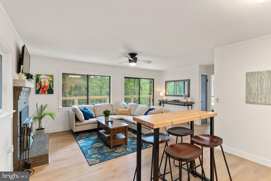 Situated on 2 wooded acres, in the tranquil Lost River Valley of West Virginia this fully furnished meticulous renovation provides privacy and serenity, making it an ideal haven for those looking to escape the hustle and bustle of city life. Inside features an open living space with a wood-burning fireplace that is perfect for cozying up on chilly evenings and seamlessly integrates with the intimate and modern kitchen. The large windows allow for abundant sunlight to fill the space and the views of the surrounding wooded acres from every room provide a connection with nature creating a serene and relaxing environment.  

Step outside onto the wrap around deck that is ideal for enjoying your morning coffee or hosting a summer BBQ. Ample parking and a wide driveway await your guests and the expansive flat lot is a dream for entertaining.  Equipped with a fire pit area, hot tub and even a horseshoe/cornhole space you will always have plenty to do.  Lighted path leads from the house into the woods to several hiking trails. There is also a large outdoor shed for storing gear or small vehicles.  And for those electric car owners a new EV charger has also been installed and is ready and waiting to charge you up.

The community of Snyders Ridge has minimal restrictions and a lovely park-like setting and is so quiet that the road is a perfect trail for evening strolls.  Don’t be surprised if while you are meandering along you are invited in to one of the neighbors’ homes for libations and delightful conversation. Located just a short drive from George Washington National Forest, Trout Pond Recreation Area and under 3 miles from Lost River State Park, outdoor enthusiasts will appreciate the abundance of hiking, fishing, horseback riding, swimming and other recreational opportunities in the area.  Lost & Found Pizza & Provisions is just a 5 min drive offering hand tossed wood fired pizza and a curated beer, wine and snack selection you are bound to love. Start your day with a morning latte and breakfast at Drifters Café which is located inside the Provisions Store.  Hit the LRV Gym for a quick workout and grab lunch or dinner at Lost & Found Pizza and Provisions. Don’t forget to grab a bottle of wine or your favorite craft beer from the Provisions Store.