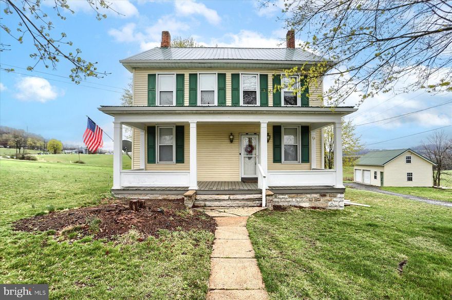 Spacious home and country living! You are close to schools and community park, there is so much to love about this home. It has been cared for and enjoyed for so many years and now is the time to make your memories here.  You can sit and relax on the large covered porch at the end of the day or start the day with a cup of tea or coffee. The bath was remodeled in 2022 and there is a walk in closet on the second floor. In addition to the covered front porch there is an enclosed 10x6 rear porch.  For the cook in the family there is an island in the kitchen. There are hardwood floors and we believe hardwood under the existing carpet that is a couple of the rooms. A walk up attic means more storage as does the storage/workshop above the two car garage. The water conditioning system is owned not leased. The wardrobe in the 2nd floor BR will remain. ALL OFFERS MUST BE SUBMITTED BY APRIL 13TH AT NOON.