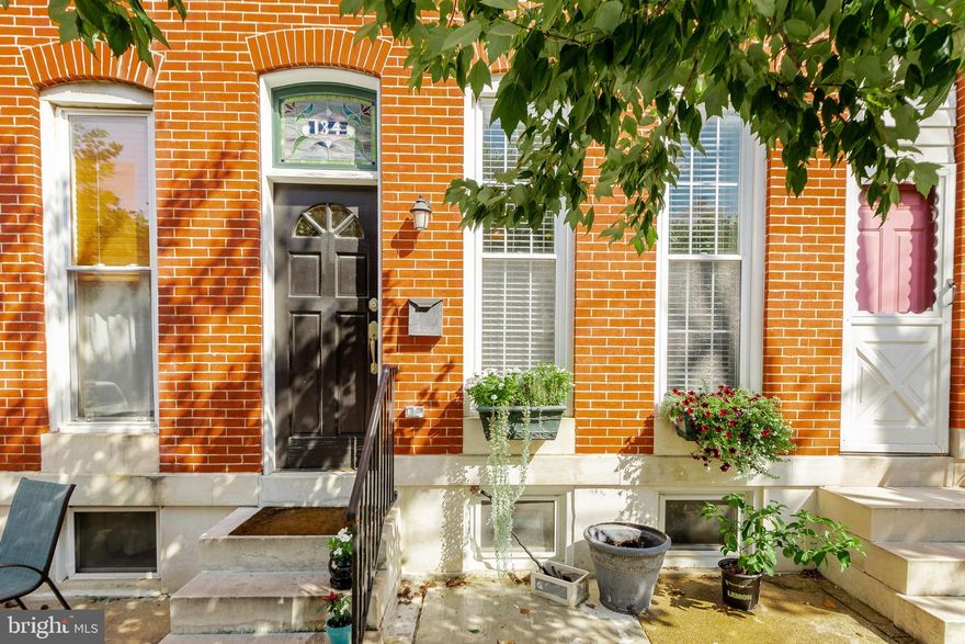 Baltimore charm at its best! Marble stoop, stain glass window, and meticulous brick work  welcome you into hardwood floors, high ceilings, and a modern, open floor plan.  Completely renovated in 2017 and new hardwoods added with present owner.  Don't miss the parking pad in the back and the fantastic spacious rooftop deck 28X10 with panoramic views for all your entertaining needs.  This 2 Bedroom 2.5 bath home has fantastic storage and thoughtful design.  A must see!