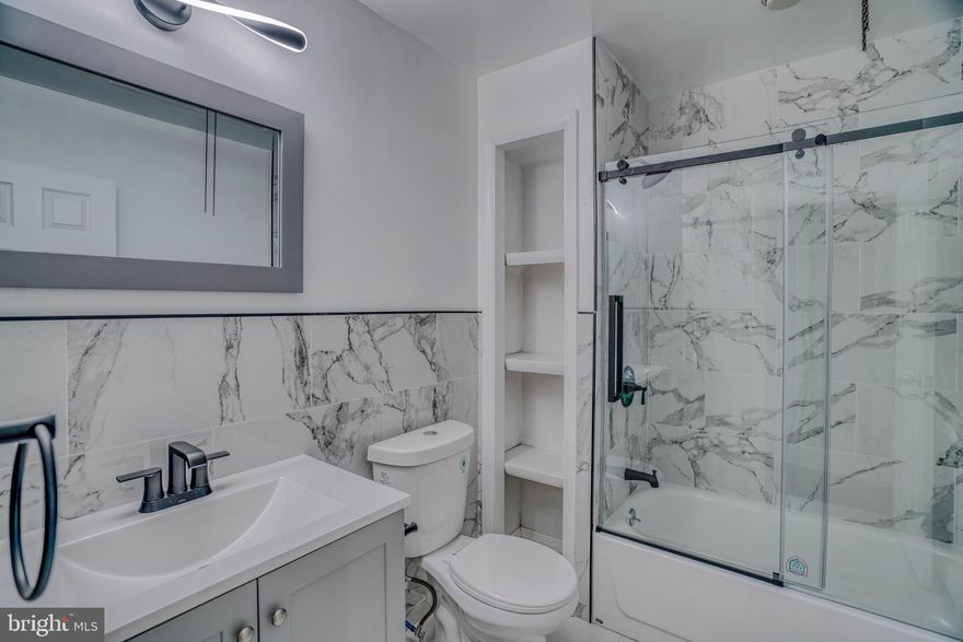 Welcome to 2135 Granite Street — a beautifully renovated, move-in-ready home in the heart of prime Wissinoming.

This solid, thoughtfully executed renovation offers the perfect blend of modern finishes and classic charm, all in an ultra-convenient location just minutes from I-95, the Betsy Ross Bridge to New Jersey, Center City Philadelphia, and Philadelphia International Airport.

Step onto the inviting covered front porch and into a sun-filled formal living room featuring refinished hardwood floors, recessed lighting, and clean architectural lines that set the tone for the rest of the home. The adjacent dining area continues the hardwood flooring, creating a seamless flow ideal for entertaining.

The brand-new kitchen is a showstopper—designed for both style and function—with new cabinetry, quartz countertops, gas cooking range, stainless steel exhaust fan, stainless steel sink, modern faucet, recessed lighting, base moldings, and a stainless steel double-door refrigerator. A rear exit leads to the private backyard, complete with a new PVC privacy fence, perfect for outdoor enjoyment.

The second level offers three generously sized bedrooms, all with hardwood flooring, recessed lighting, and base moldings. The stunning, newly renovated hall bathroom features marble floors and walls, a skylight that floods the space with natural light, a new vanity, modern fixtures, a glass sliding shower door, and a convenient linen closet.

The fully finished basement expands the living space dramatically, showcasing recessed lighting, modern exposed beams, new vinyl flooring, and a glass block front window. This level also includes a brand-new full bathroom with tiled floors, subway-tiled walls, glass-enclosed stall shower, vanity, and modern fixtures. Additional highlights include all-new electric, a new Weil-McLain natural gas hot water boiler, new hot water heater, and a brand-new washer and dryer.

3 bedrooms | 2 full bathrooms | Finished basement | New everything

This home checks every box—location, quality, and turnkey condition. Schedule your private tour today and experience 2135 Granite Street for yourself!