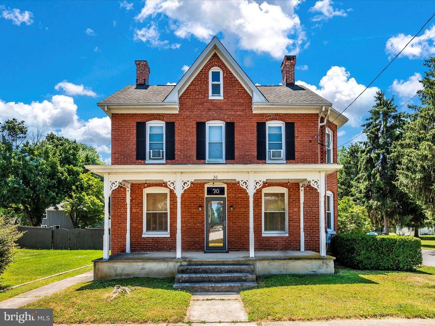 *******OPEN HOUSE Saturday 7/6 10am-12pm*******Beautiful brick colonial in the quaint town of Walkersville offers a perfect blend of traditional elegance and modern comfort. With its charming architecture and detailed designed interiors, this home is ideal for those seeking a timeless yet functional space. The main level features a traditional style living room and family room with craftsman trim along with a beautiful kitchen, boasting custom Cherry cabinets that provide a rich classic look while offering practical storage space. The heart of this home is the grand family room designed for entertainment and relaxation. The impressive 13 ft. cathedral ceilings with exposed wood beams create a sense of openness, while the skylights provide natural light. This room is perfect for gatherings, movie nights of simply unwinding after a long day. The 2nd floor includes three spacious bedrooms , a 2nd bathroom and beautiful original hard wood floors. In the large attic you will find a completely finished space with unlimited options. The exterior features of the home include two covered porches perfect for morning coffee, evening relaxation , or hosting outdoor get-togethers.  The over-sized detached 2-car garage provides plenty of space for parking, storage, or hobbies.  Its size accommodates larger vehicles or can serve as a workshop, enhancing the property's versatility. Enjoy a small town feel with the benefits  of modern amenities and close proximity to major highways and attractions.