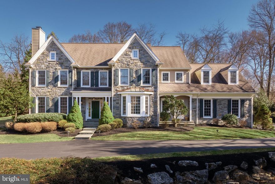 Welcome to 815 Brower Road, where refined elegance meets the serenity of nature. Nestled on a private 1.2-acre lot between St. David’s Golf Club and McKaig Nature Center, this exquisite 5-bedroom home has 4 full baths and 3 half baths, spanning nearly 6,300 square feet (not including the finished basement!). This gray stone masterpiece boasts an oversized 3-car attached garage and a separate 2-car detached garage, providing ample space for living, storage, and beyond.

Step through the front door into a grand foyer, where a custom staircase and overhead catwalk create an unforgettable first impression. To the left, there is a wonderfully cozy formal living room warmed by a gas fireplace, and to the right, a dramatic dining room with a bay window perfect for gatherings. At the heart of the home lies a chef’s dream kitchen featuring abundant custom cabinetry, a large two-tier island, two dishwashers, a desk nook, and a butler’s pantry. Versatile living spaces invite you to unwind in the great room/family room or bask in sunlight in the morning room/4 seasons sunroom—both offering the property’s best views, gazing out over the private backyard. A secluded office/library and perfectly placed laundry/mud room round out the first floor.

Take either the main staircase or the back staircase just off of the kitchen to the second floor, where the master suite awaits as a true sanctuary, complete with a private sitting room with a gas fireplace, a spa-like bath with twin vanities, a soaking tub, and an oversized shower, plus two spacious walk-in closets. Three additional generously sized bedrooms include a princess suite with its own adjoining bath. The third floor provides incredible flexibility—configure it as an au pair suite with a bedroom, living room, and full bath, or transform it into two extra bedrooms to suit your needs. Ample storage and closet space throughout keep everything effortlessly organized.

The walk-out basement is an entertainer’s dream, offering 9+ foot ceilings, a wet bar, a billiard area, a playroom, vast storage, and an authentic wine cellar and tasting room—perfect for wine enthusiasts. Step outside to a large flagstone patio enveloped by lush greenery and completely fenced in to keep the dogs or kids safe. The long private drive enhances the estate’s seclusion, while its classic gray stone exterior radiates enduring charm.

Perfectly situated near top-rated schools, prestigious country clubs, swim clubs, shopping, and major highways, 815 Brower Road combines peaceful seclusion with easy access to downtown Philadelphia and beyond. Don’t miss this rare chance to own a slice of paradise in Wayne—a home where luxury, space, and nature come together in perfect harmony. Schedule your visit today!