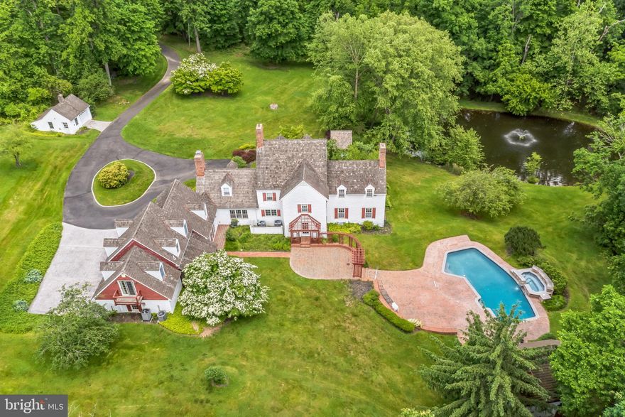 Welcome to a stately farmhouse, nestled on eight plus acres of lush greenery, where tranquility meets nature . Imagine a long, winding driveway, guiding you towards a delightful farmhouse.   A stocked pond with an air aerator, creating an enchanting spectacle of water and light, surrounded by panoramic views that stretch far into the horizon. An experience that truly defines a private setting. Now, picture a custom pool coupled with a spa, and a charming pool house that is an OASIS perfect for summer entertainment. Just a stone's throw away, find a second garage, offering ample storage, a testament to the thoughtfulness in design. Enter the home to a large foyer and grand staircase welcome into the world of elegance. The formal living room, adorned with a cozy fireplace and the dining room with built-in cabinets and shelves, are perfect for hosting and relaxing. A large study, filled with built-ins, and fireplace provides the ideal sanctuary for work or quiet reflection. The heart of the home, the kitchen, boasts granite tops, an abundance of cabinets, stainless steel appliances and a gathering area. The large wood-burning fireplace, beamed ceilings and walls, and built-in cabinets, wet bar make this space perfect for family gatherings. Adjacent to this, find a large family room with a bay window with scenic views paneled wall, and tile flooring. Two powder rooms and a laundry room conveniently complete the first floor. Retreat to the owner's suite, equipped with a fireplace and new luxury bathroom, or to one of three additional bedrooms. Two hall bathrooms complete the second level, while the third floor remains unfinished, ready for your personal touch perfect for another bedroom or game room. A screened-in porch with brick flooring, and a brick walkway that surrounds the house, leading to a large brick patio at the back, create a warm and welcoming exterior. Additionally discover an apartment with a separate entrance, perfect for guests, or au pair suite. Other features: Hardwood flooring, 4 fireplaces, covered porch 3 brick patios, 3 car attached garage 1 oversized detached garage and storage, 2 electric hot water heaters, security system, springhouse, macadam and stamped concrete driveway, private road, water softener, pool house with a loft, full bath and kitchenette, all machancials updated. This estate, located within the Council Rock Schools district and with easy access to Philadelphia, New York, New Hope, and Newtown, is truly a rare find and a gem for the discerning buyer.