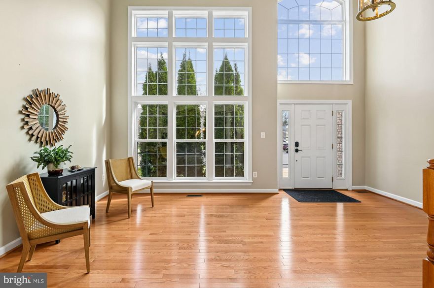 Welcome to 614 Crawfords Ridge — Located in a welcoming 55+ community, WITH UP TO 20% of residents under the age permitted with RESTRICTIONS-no one under 48 and no children younger than upper teens!  This home is a beautifully maintained white‑brick Colonial tucked into a quiet cul‑de‑sac, offering over 4,000 sq ft of thoughtful design, natural light, and modern comfort.
Step inside to an open floor plan with hardwood floors throughout, high ceilings, and a warm, inviting fireplace. The large family room flows seamlessly into an updated kitchen featuring gas cooking, granite countertops, abundant counter space, a pantry, an island and a dining area. 
A versatile office space on the main level can easily function as a first‑floor bedroom, complemented by a convenient half bath. Off the back of the home, enjoy brand‑new decking, with Awnings that provide more shade when needed and are perfect for entertaining or relaxing while overlooking peaceful woods for added privacy.
Upstairs, you’ll find four spacious bedrooms and three full baths, including a generous primary suite with double sinks, granite counters, and a beautifully appointed primary bath. The laundry room is thoughtfully located on the bedroom level.
The refinished basement expands the living space with great lighting, fabulous wood floors and a bar with sink, a full bath, and walkout access—perfect for guests, hobbies, or recreation. Also, it offers plenty of storage. 
HVAC's were replaced 2024,  booster pump in 2022 and solar tint on windows that convey to the new owners with a warranty.  There is an irrigation system with a control panel that was replaced in 2024.  The home also includes a dehumidifier for more comfort on those humid Maryland summer days. 
      Located in a welcoming 55+ community, WITH UP TO 20% of residents under the age permitted with RESTRICTIONS-no one under 48 and no children younger than upper teens! The home backs to woods, providing privacy while being close to walking paths and major highways for an easy commute.
A rare blend of space, style, and location—this home is truly move‑in ready.