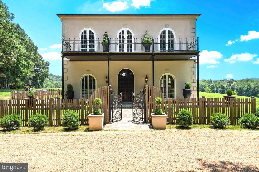 This exceptional country manor in Warrenton, Virginia, offers a truly enchanting retreat on nearly 55 private acres. It unfolds like a storybook, starting with a gated entrance that leads you down a nearly half-mile carriageway. As you drive through, it feels as though you are meandering through a magical forest, only to emerge into a striking open vista.
The residence commands attention from the moment you arrive, leaving a special first impression that captivates the heart.
This heritage-inspired 3-bedroom home, featuring a versatile bonus room that can serve as a fourth bedroom, forges a deep connection to its surroundings with a sophisticated design that seamlessly blends the essence of hunt country.
Every detail tells a story, from the grand front doors to the elements inside, including architectural beams, trim, hardware, and lighting salvaged from historic estates across America, lending extraordinary old-world charm to this 2012-built masterpiece.
 Most furnishings convey, allowing the space to showcase its soaring 12-foot ceilings and oversized 30-foot living room, enhanced by thoughtfully curated designer wall treatments that add depth and elegance.
The kitchen is a delightful escape, reminiscent of a European holiday, featuring a vintage floor-to-ceiling cupboard and a luxury La Cornue range. Natural light floods every corner, with private views from every window that ensure you'll never tire of the Virginia countryside—particularly during your first sunrise or sunset here, an experience that truly captivates.
The primary suite features a spacious bedroom with direct access to a large deck with unobstructed views of the pastures. The marble primary bathroom suite is a true sanctuary, complete with a walkout to a charming front balcony, blending luxury and comfort seamlessly. This space is not only filled with natural light but also ensures an exceptional level of privacy.
The second floor features up to three more thoughtfully designed bedrooms, complemented by an updated marble bathroom. A versatile loft area offers potential as a sitting room or office, enhanced by double doors that open to the front balcony deck.
The estimated 1,700 square foot unfinished lower level, offers potential for additional livable space. Practicality meets elegance with the inclusion of a whole house generator.
Surrounded by stunning, sprawling pastures and lush wooded areas, the grounds feature a serene section along the tranquil Great Run waterway, enhancing the beauty at the back of the property. This home also borders the historic 1,300-acre North Wales estate—once the residence of Walter Chrysler and under conservation easement. The recent $20 million sale of this expansive farm further amplifies the 55 acres, making it feel even more substantial. With no easement, there is potential for expansion, inviting endless possibilities to this already breathtaking landscape.
The manor is conveniently located less than 10 minutes from the vibrant shopping and dining options of historic Old Town Warrenton, offering the perfect blend of serene living and accessibility. Additionally, you are only 45 minutes from Dulles International Airport. It’s a remarkable fusion of town and country living that is highly sought after today. 
This property is more than a home; it is a distinctive experience waiting to unfold in a setting that invites stewardship of its exceptional beauty.