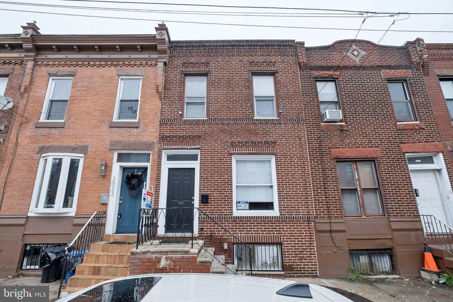 Now is your time to call South Philly your home! The house you’ve been looking for is at 2025 S 22nd Street. Approach a classic brick facade row home and enter into a beautiful, quaint foyer with a penny tiled floor, a unique feature to this house you don’t see often! Enter into the home to see a beautifully, renovated property showcasing, neutral tones throughout all of the new flooring, painting, recessed lighting, and the open concept for you to see all the way back to the kitchen. This straight through design offers functionality for living day-to-day as well as hosting for years to come. The living room area is quite spacious and allows for natural lights to flow through the front two bow windows. Take in the newly installed wrought iron railings, spacious dining area, and fully upgraded kitchen, featuring new cabinetry, granite countertops, as well as a coordinating tiled backsplash to match. The tiled floor also makes quite the statement! Beyond the kitchen is the back laundry room, convenient being on the first floor. Through here you have access to your private patio. Make your way upstairs to discover three bedrooms. The front facing largest bedroom and the middle bedroom share a full bathroom in the hallway, which has a jetted jacuzzi style tub. The back bedroom is ready for your warm welcome as it also has its own full bathroom, showcasing the same aesthetics has seen throughout with a walk-in shower stall. The finishing touches continue as you discover a full finished basement, but first before you walk down, take in the stonewall feature that has been placed. This property boasts all of the modern aesthetics that buyers are looking for today. Consider adding seeing 2025 S. 22nd St. to your list of houses today!