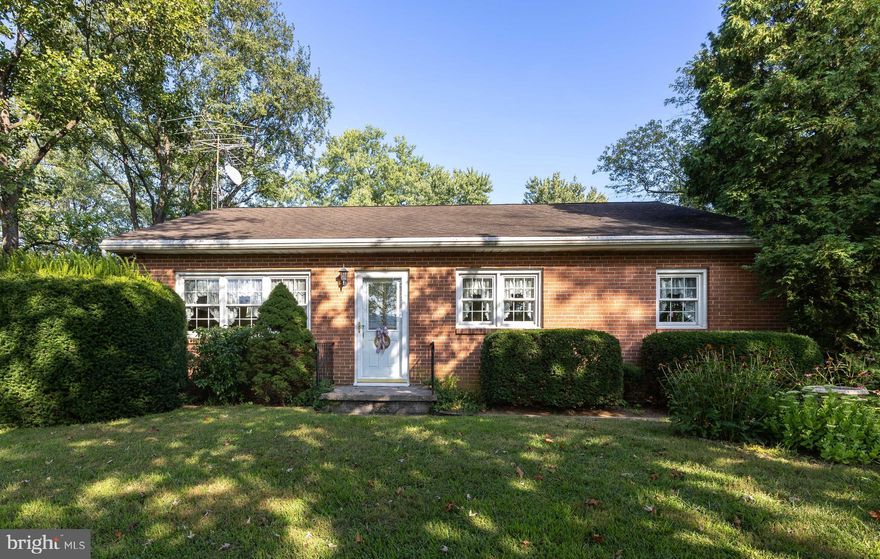 IMPROVED PRICING!  VISIT THIS PROPERTY TODAY!
Welcome to the “Garden of Arden” – a name the current owners lovingly gave their home for its serene pastoral views of surrounding farms and orchards. This charming 3-bedroom, 1-bath brick rancher rests on 2 unrestricted acres, offering privacy, beauty, and a true country retreat.

Step inside to discover a newly updated kitchen featuring KraftMaid cabinetry, quartz countertops, GE Profile stainless steel appliances, and durable LVT flooring – a cook’s dream. The kitchen opens to the dining area, making mealtime and entertaining effortless. The spacious living room showcases a brick gas fireplace, perfect for cozy winter days, and a large picture window framing captivating orchard and mountain views. Down the hall, three comfortable bedrooms and a full bath with timeless oak flooring, oak, and walnut trim complete the main level.

The full daylight basement adds versatility with plenty of storage, built-in shelving, and multiple finished spaces. A dedicated office makes working from home a breeze, while the paneled den—featuring two closets and a window—offers potential as a fourth bedroom. The large laundry/workshop area provides endless possibilities for hobbies, crafts, or projects.

Outdoors, the property shines with mature hardwoods (Hickory, Ash, Oak, Walnut, Paw Paw, Sugar Maple, and Mimosa) that provide shade, privacy, and vibrant fall color. In spring, flowering Dogwoods, Redbuds, and Snowball bushes add seasonal beauty. Enjoy gatherings on the deck, shoot hoops on the basketball court, or take in the fresh country air with linens dried on the line.

All of this tranquility is just minutes from I-81, shopping, and dining, giving you the perfect balance of peaceful living and everyday convenience.