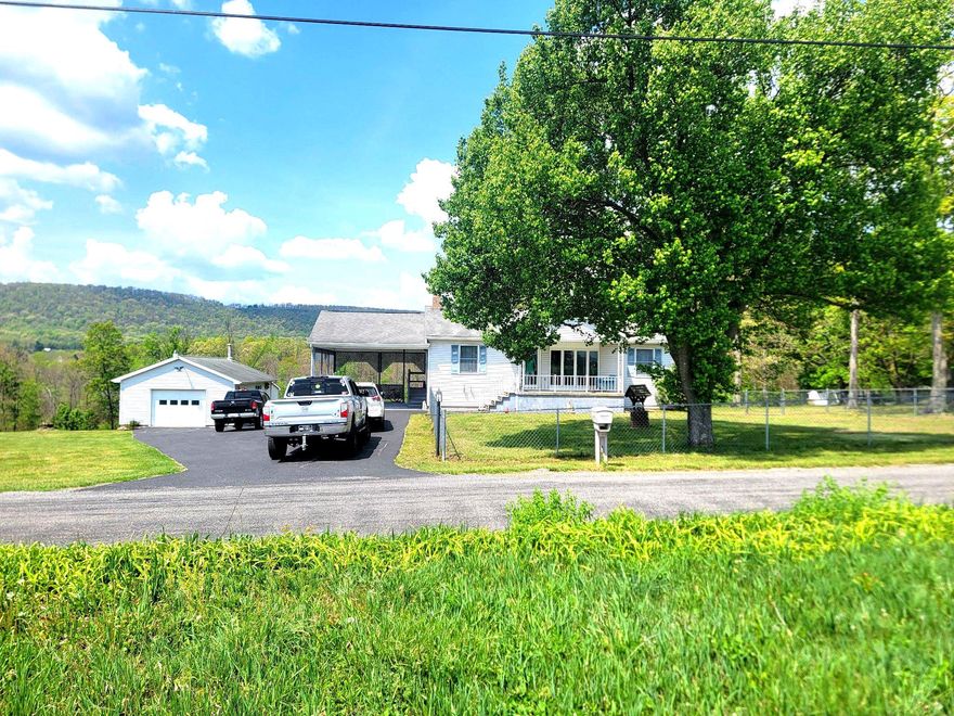 This charming, raised ranch offers a perfect blend of comfort and functionality. With three spacious bedrooms and two full bathrooms, this home is designed for both relaxation and entertaining. The heart of the home features a delightful kitchen with ample table space and a pantry, ideal for culinary enthusiasts. The fully finished basement, complete with a second kitchen and walkout access, provides endless possibilities for recreation or hosting guests. Outside, the expansive 1.98-acre lot offers plenty of room for outdoor activities, complemented by an attached carport and a detached garage for all your storage needs. Experience the warmth and charm of this well-maintained home, where every detail invites you to create lasting memories.