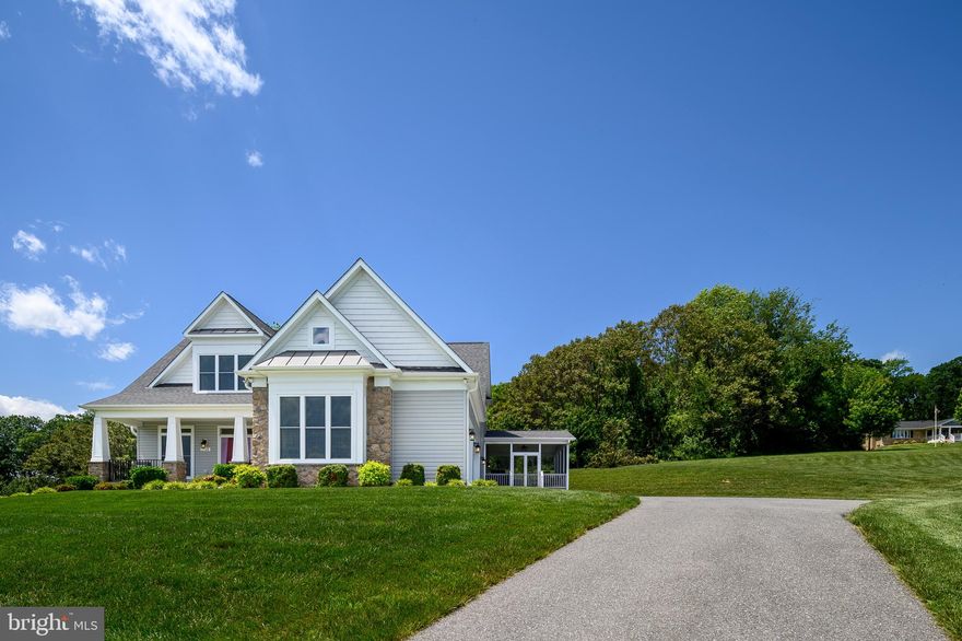 Welcome to this exceptional custom Craftsman-style home, designed by Frank Betz and set on 3.5 private acres in Western Howard County, within the highly sought-after Glenelg school district. Surrounded by mature woods and beautifully landscaped grounds, including 26 red maple trees planted by the county, this property offers a rare combination of seclusion, luxury, and convenience. Inside, you’ll find over 4,500 square feet of finished living space with an open floor plan filled with natural light and hardwood floors throughout the main level. The gourmet kitchen is a standout feature, complete with an oversized 9’ x 5’ quartz island, ample cabinetry, a walk-in pantry, and Whirlpool appliances. A butler’s pantry and versatile bonus room—ideal for a dining room, home office, or creative space—add flexibility to the main living area.

The main-level primary suite offers two walk-in closets and a spa-inspired ensuite bath with a large walk-in shower. Upstairs, a spacious loft provides an additional gathering space, and each of the generously sized bedrooms includes its own private bath and walk-in closet. The partially finished basement includes a large recreation room and a full bathroom, with an additional 700 square feet of unfinished space available for future customization. Practical amenities include a tankless hot water heater, a whole-house generator, and Fios internet for uninterrupted comfort and connectivity. A 3-car garage and a 14' x 24' shed with electricity provide ample space for hobbies, storage, or workshop needs.

Outdoors, enjoy the expansive 16' x 24' screened porch—perfect for relaxing, grilling, or entertaining guests. Located in a quiet, low-density neighborhood surrounded by farmland and parkland, this home offers peaceful living just a short drive from everyday conveniences. With its refined finishes, spacious layout, and natural setting, this one-of-a-kind property offers a truly elevated lifestyle in one of Howard County’s premier locations.