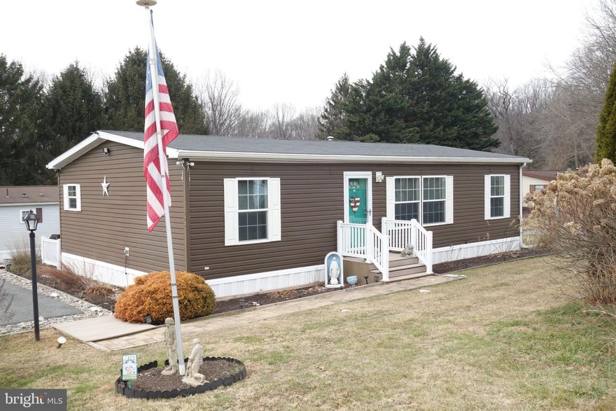 Welcome to this 2017 Chesapeake Series Eagle River doublewide mobile home, that has been lovingly cared for by the original owners. 9 x14 3 season room, fenced yard area, 3 car paved parking area and a shed are additions you’ll love.  Lovely eat in kitchen is the perfect gathering area. Numerous cabinets and generous counter space combine with a large island, pantry, double sink with a hands-free spigot, propane range for the serious chefs and a newer Kitchen aid stainless dishwasher. Laundry room opens off the kitchen to aid in your domestic chores and provides more great pantry space. Large open living room features a ceiling fan, crown molding and large windows to flood the room with light. Primary bedroom suite is located at its own end of the home. Ceiling fan and large closet are joined by its own bath that features a soaking tub, shower and linen closet. 2 bedrooms, with ceiling fans, are located at the other end of the house where they are served by a hall bath with tub/shower and crown molding. Additional features are outdoor security cameras, conveniently located outdoor motion detector lights, 2024 hot water heater, new ac compressor and an owned propane tank that allows the buyer to shop for pricing. The sellers have maintained a 2-time a year maintenance contract with Rapid Repair that services the heater, inspects the roof, inspects under the home for the heat tape etc. and performs spring and fall maintenance items. All buyers must be approved by the park. Current lot rent is $685 a month and includes trash. See documents in Bright for the Manufactured Home Community Rights Act Notice, the Park application and the Rules and Regulations and Park Fee Schedule.