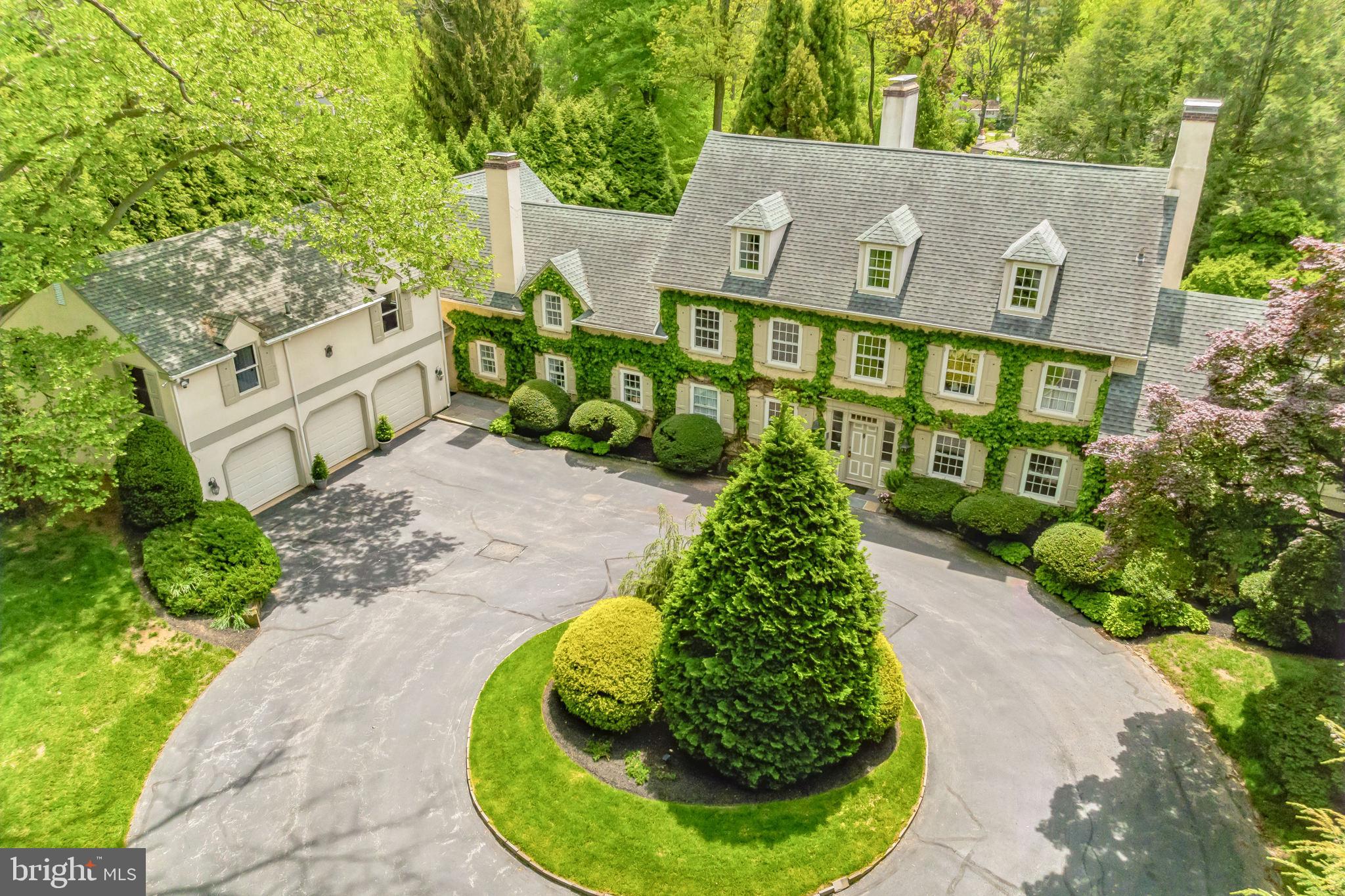 Welcome to "Boxwood, a Landmark Estate Property in one of the Main Line’s most coveted locations! This classic , circa 1895 Colonial Revival manor home has been respectfully maintained, updated and expanded over the years and the evolution has created a wonderful well scaled family home with all the right modern living spaces for today while maintaining the timeless, and refined millwork, finishes and ambiance of the early 20th century. Large windows throughout take full advantage of the southern exposure and outstanding garden views, including the walled garden. On the first floor; the formal entry hall, elegant living and dining rooms all have outdoor access to the expansive terrace and gardens, original hardwood floors and fireplaces. Off the living room is a dramatic vaulted ceiling great room with fireplace, custom-built cabinets, 4 sets of French doors that open to the terrace and walled garden - a spectacular room in every way. A delightful newly updated Butlers Pantry is off the dining room and leads into the new, top of the line chef’s kitchen with custom wood cabinetry, honed marble and granite countertops, island breakfast bar, a 6- Burner Wolf Gas Range, 2 Bosch dishwashers, Subzero Refrigerator, & walnut floors - all adjacent to a large family dining area and step down family room with triple French doors out to the terrace and back yard. A service area/mud room off the kitchen includes the laundry room, storage closets, entrance to the 3 Car garage, and staircase up to the newly renovated apartment/entertaining space over the garage. The apartment includes a spacious living room/ dining room combination, fabulous bar/kitchen, and large bedroom with full bath - whether its a guest suite, office, or cocktail club destination, it's a lifestyle bonus! The front and back staircases each access the second floor of the home which includes; primary suite with bath, bedroom and 2 walk in closets, a bedroom or primary suite sitting room or study and hall full bath, 2 ensuite bedrooms each with private baths. The 3rd floor has 2 bedrooms and a new full bath. The basement is unfinished, dry and excellent for storage with bilco doors outside. Two additions have expanded the property over the years; the 3-car attached garage with a one-bedroom apartment was added in the early 1970’s, the family room off the kitchen and second floor primary suite was addend in the 1990’s. The result is a private, gracious, and timeless gated 3 story estate home surrounded by over an acre of expertly landscaped grounds, with , exquisite gardens, heated pool & spa, terraces and a treasured walled garden from another time and place - a beautiful room unto its own .
This special property meets today's evolving lifestyle standards in one of the most coveted and convenient Main Line Locations . Highly ranked educational institutions including the acclaimed Radnor Township School District, major commuting routes, Center City Philadelphia, Philadelphia International Airport and the town of Wayne are all minutes away. The Radnor Trail, and the town of Wayne, are an easy walk or bike ride away.