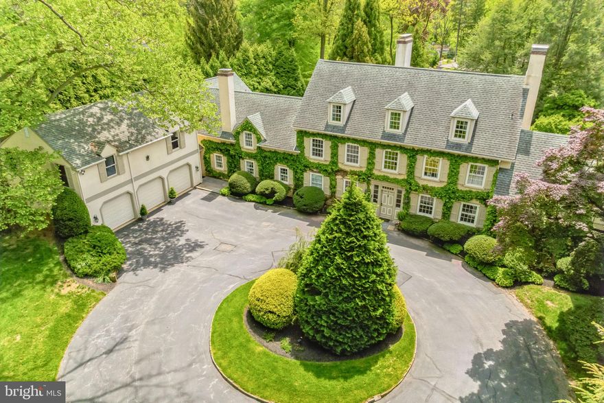 Welcome to "Boxwood, a Landmark Estate Property in one of the Main Line’s most coveted locations!  This classic , circa 1895 Colonial Revival manor home  has  been respectfully maintained, updated and expanded over the years and the evolution has created a wonderful well scaled family home with all the right modern living spaces for today while maintaining the timeless, and refined millwork, finishes  and ambiance of  the early 20th century. Large  windows throughout take full advantage of the southern exposure and outstanding garden views, including the  walled garden.  On the first floor; the formal entry hall, elegant living and dining rooms all have outdoor access to the expansive terrace and gardens, original hardwood floors and fireplaces. Off the living room is a dramatic vaulted ceiling great room with fireplace, custom-built cabinets, 4 sets of French doors that open to the terrace and walled garden - a spectacular room in every way.  A delightful newly updated Butlers Pantry is off the dining room and leads into the new, top of the line chef’s kitchen with custom wood cabinetry, honed marble and granite countertops, island breakfast bar, a 6- Burner Wolf Gas Range,  2 Bosch dishwashers,  Subzero Refrigerator, & walnut floors - all adjacent to a large family dining area and step down family room with triple French doors out to the  terrace and back yard. A service area/mud room  off the kitchen includes the laundry room, storage closets, entrance to the 3 Car garage, and staircase  up to the newly renovated apartment/entertaining space over the garage. The apartment includes a spacious living room/ dining room combination, fabulous bar/kitchen, and large bedroom with full bath - whether its a guest suite, office, or cocktail club destination, it's a lifestyle bonus! The front and back staircases each access the second floor of the home which includes; primary suite with bath, bedroom and 2 walk in closets, a bedroom  or primary suite sitting room or study and hall full bath, 2 ensuite bedrooms each with private baths. The 3rd floor has 2 bedrooms and a new full bath. The basement is unfinished, dry and excellent for storage with bilco doors outside. Two additions have expanded the property over the years; the 3-car attached garage with a one-bedroom apartment was added in the early 1970’s, the  family room off the kitchen and second floor primary suite  was addend in the 1990’s. The result is a private, gracious,  and timeless gated 3 story estate home surrounded by over an acre of expertly landscaped grounds, with , exquisite gardens, heated pool & spa, terraces and a treasured walled garden from another time and place - a beautiful room unto its own .

 This special property meets today's evolving lifestyle standards in one of the most coveted and convenient Main Line Locations . Highly ranked educational institutions including the acclaimed Radnor Township School District,  major commuting routes, Center City Philadelphia, Philadelphia International Airport and the town of Wayne are all minutes away. The Radnor Trail, and the town of Wayne, are an easy walk or bike ride away.