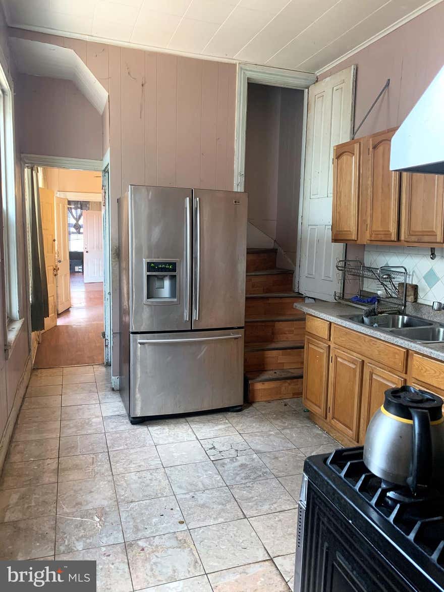 Investors, here is a 2 for 1 deal. Seize this great opportunity to renovate this large 5 bedroom , 2 bath home, almost 2000 sq ft. This is an as-is sale, cash only. The home features a main floor laundry and a basement laundry. All the appliances are in working order and stay with the home, a SS refrigerator, gas stove, 2 washers and 1 dryer. The main floor has a large living room, a large living room and a nice sized kitchen and a full bathroom. Upstairs there are 3 bedroom and a main bath and two more bedrooms on the third level- all are private. This home comes with the lot/yard of .04 acres- the home and the lot are on 1 deed. House taxes are 831 , lot taxes are 229. There is great potential with the lot, off street parking, a patio area, a huge garden, plus there is a tool/garden shed along side the home. The back yard has an Asian pear tree,and  a grape vine . The front of the home was being scrapped to be repainted but the work was not completed. This home is worth the look. Make your appointment today.