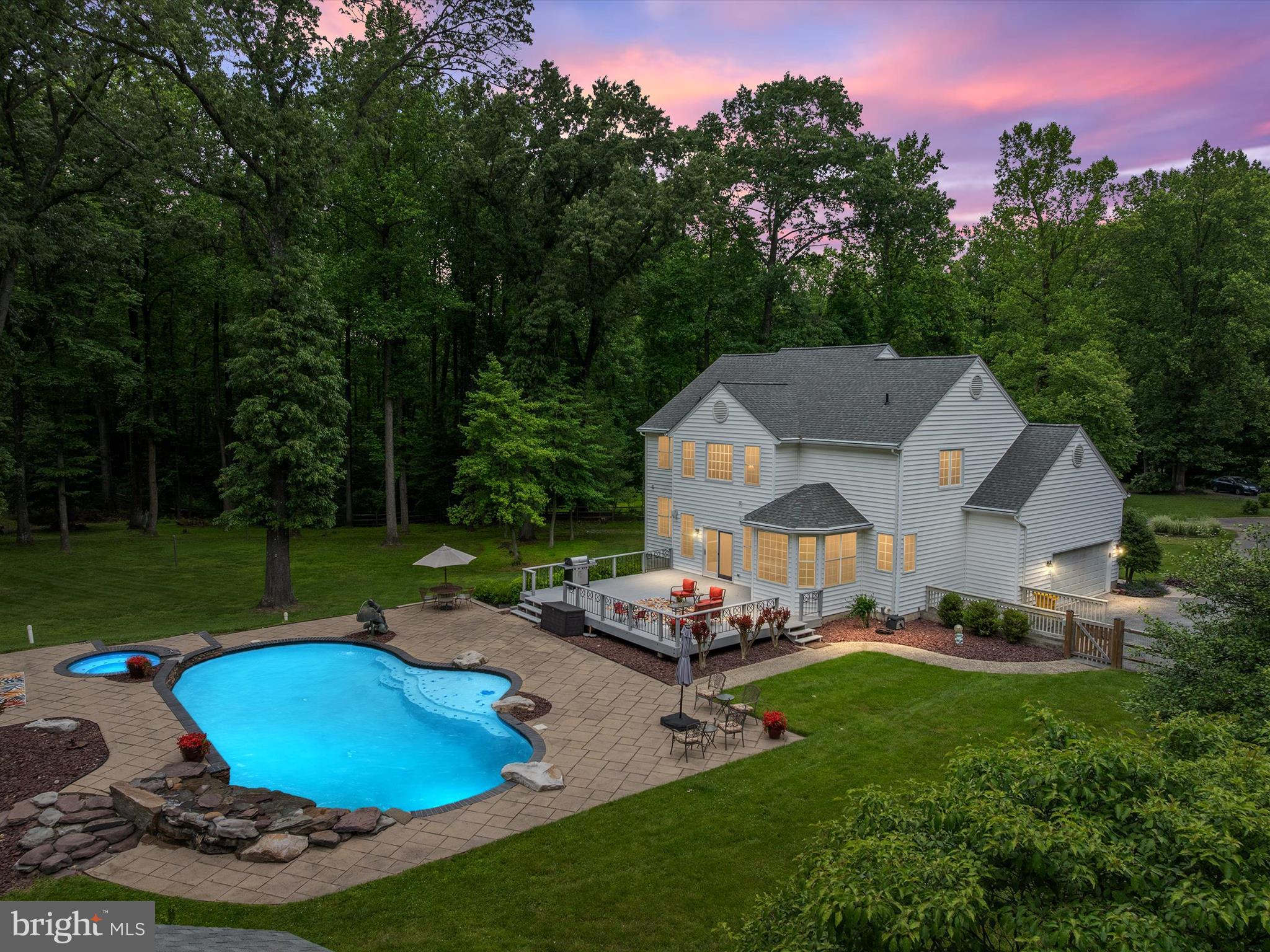 Sellers new construction home is nearly complete and they are ready to make a move—making this an INCREDIBLE OPPORTUNITY for you! This breathtaking estate sits on seven private acres and offers the ultimate blend of indoor elegance and outdoor paradise. A picturesque tree-lined street welcomes you to this stunning home where resort-style living begins with a heated saltwater pool, cascading waterfall, spa, gas fire pit, and multiple patio areas-perfect for entertaining or relaxing in total privacy.
Inside, a dramatic two-story foyer opens to formal living and dining rooms, leading to a spacious kitchen that flows seamlessly into a warm and inviting family room with a fireplace and direct access to the deck. The bright breakfast room offers tranquil pool views, and a main-level study provides a private workspace. Upstairs, the luxurious primary suite features two walk-in closets, dual vanities, and a spa-inspired ensuite bath. Three additional generously sized bedrooms, a full bathroom, and laundry complete the upper level.
The finished lower level is a true entertainer’s dream, complete with a large wet bar, kegerator, two wine refrigerators, five wall-mounted TVs, a pool table, foosball table, and a built-in multi-gun safe (all of which convey). A bonus room offers flexible space for a home gym, guest suite, or second office, and the sleek full bath features designer tile finishes.
The grounds are just as impressive! Imagine mornings by the pool, evenings by the fire, and weekends surrounded by nature. The manicured two-acre lawn transitions into five wooded acres filled with mature hardwoods, where deer and turkey roam freely in their natural habitat. The oversized two-car garage includes Gladiator cabinetry and a workbench, while the powered shed-complete with its own breaker box and finished office space-offers a year-round workspace or studio. A professional FLIR video surveillance system with indoor and outdoor cameras provides peace of mind, with all equipment discreetly housed in the basement.
This home offers unmatched privacy, space, and lifestyle—all within easy reach of commuter routes, shopping, and dining. While some road noise is present, it is fully reflected in the HUGE price reduction-making this an exceptional value for a home of this caliber. Come for the experience—stay for the lifestyle
New roof (2023). Full basement remodel (2020).
