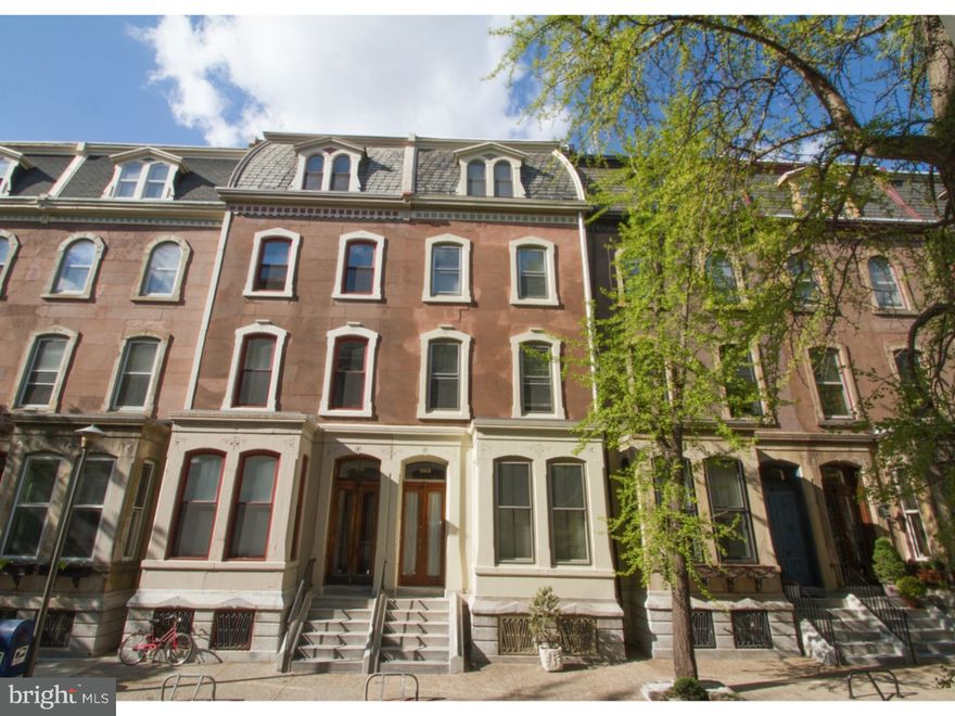On one of the finest tree lined blocks in all of Center City, discover this once in a lifetime opportunity to own a grand and immaculate, 5 bedroom, 3.5 bath historic home. The exquisite elegance and handsome details of this property cannot be overlooked, with soaring ceilings, light hardwood floors with oak trim, crown moldings and wainscoting, original grand staircase and several ornate marble fireplace mantles. Throughout the house you will find an abundance of large windows allowing natural light to illuminate each of the rooms, all of which boast tremendous closet space and unique built-ins. Sophisticated foyer entry to formal living room. Tall, original archway leads into formal dining room. Sun filled kitchen with glass tile back splash, curly maple cabinetry, granite counters, island bar counter, pantry, heated floor and stainless steel appliances including a Wolf stove, Asko dishwasher and Subzero refrigerator. Find solace watching the sun rise with your morning coffee on the private deck with lush planted area. Luxurious second floor master suite, with dressing room, sleeping area and spacious en suite bath. Family room offers unique post-modern pillars with pediments and indirect lighting to create a unique, welcoming, warm environment. Third floor offers 2 bedrooms, vintage 60's bath and laundry room. Fourth floor boasts 2 additional bedrooms and spacious bath. Finished basement/den along with an abundance of storage space and door to small yard. Seller offering one year one car prepaid parking at Acorn Garage (22nd & Pine). A truly impeccable and sophisticated 1800s home nestled on one of the most prestigious and admired streets in not only Rittenhouse Square/Fitler Square, but all of Philadelphia.