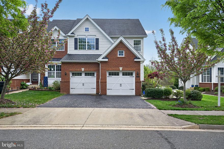 This charming Colonial townhouse in the desirable Dominion Valley Country Club community offers a perfect blend of comfort and style. With 3 spacious bedrooms 2 Full baths and 2 Half Baths, the home features a fully finished basement with a walkout entrance, ideal for entertaining or relaxing. The inviting kitchen boasts a central island and stainless steel appliances, making meal prep a delight. Enjoy cozy evenings on the deck or patio, surrounded by beautifully maintained landscaping and backing to common area. The community enhances your lifestyle with amenities such as a pool, recreation facilities, and well-kept common areas. Nearby parks provide ample space for outdoor activities, while top-rated schools ensure quality education for all ages.  Freshly painted with new upper level carpet - this home is move in ready!