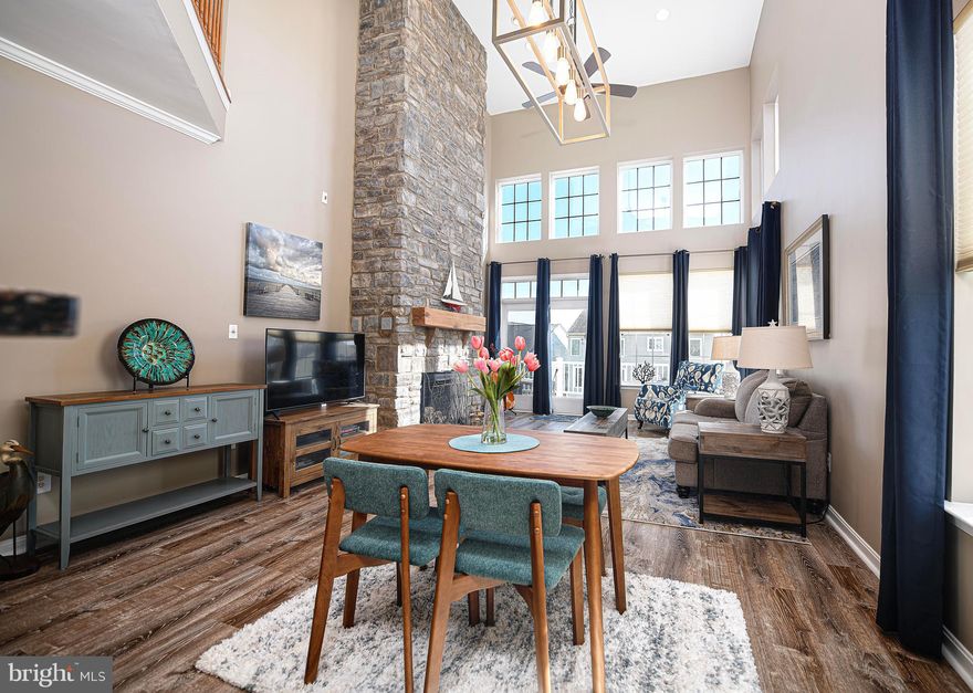 Welcome to this pristine end-of-group villa in the Bulle Rock community where life imitates vacation. This home boasts numerous updates throughout, ensuring comfort and style for its owners. As you enter the main living area, you are greeted by luxury vinyl plank flooring, complemented by neutral paint and fixtures that create a welcoming ambiance. The kitchen features 42” cabinets, granite countertops, an expanded pantry for ample storage and SS appliances. The kitchen seamlessly flows into the dining area and a two-story family room adorned with a stunning floor to ceiling stone surround fireplace. From the family room, you can access the deck which offers a privacy wall on one side and a large side yard on the other making it ideal for outdoor entertainment or relaxation. The large primary bedroom is conveniently located on the main level with a private bath and a walk-in closet, making this home perfect for one story living. For added convenience, a half bath and the laundry area are situated on this level along with access to the two-car garage featuring newer garage doors, plenty of cabinetry and overhead storage. Upstairs, there is a large loft area, providing versatile space for whatever suits you. Additionally, there are three spacious bedrooms, each with a walk-in closet and an additional full hall bath. To complete this home there is a finished lower level with a bar area perfect for hosting gatherings, a spacious recreation room for relaxation or play, a den for added functionality, and yet another full bath, providing convenience for your guests. This end-of-group villa offers a perfect blend of luxury, comfort, and functionality.