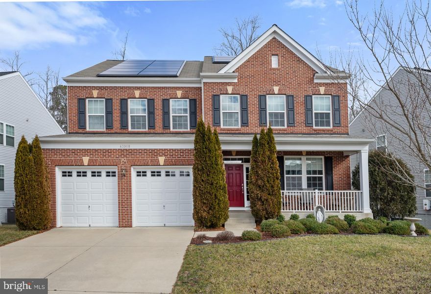 This beautiful Brick Front Colonial is located in Woodland Park at Wildewood.  **ENERGY EFFICIENT**   Outstanding features of this home include TESLA Solar Panels *OWNED* not leased!  TESLA EV Car Charger in Garage.  HOT TUB to unwind on your private rear Trex Deck backing to trees.   Every bedroom of this home offers EN-SUITE BATHS for privacy!
Main Level offers gleaming hardwood floors, an expansive gourmet kitchen with stainless steel appliances, center Island with seating, granite counter tops, upgraded 42" maple cabinetry with crown molding, gas range, pantry, and table space.  A spacious Family Room off kitchen features a gas fireplace with mantel and plenty of seating space for entertaining.   There is also a Formal Dining Room and Living Room currently being used as home office.   Upstairs you will find all Bedrooms include walk-in closets, ceiling fans with lighting,  and en-suite baths.  The Primary bedroom boasts two  expansive walk-in closets, a Luxury bath with soaking tub,  a separate walk-in shower, an extra long dual sink vanity, and gorgeous ceramic tile throughout.  Another bedroom with its own private en-suite bath and two additional bedrooms with their Jack and Jill bath.  Enormous Lower level is complete with plenty of windows letting in the daylight, a walk-out to rear yard,  a rough-in for future bath, with tons of space for rooms and finishes!  Concrete Driveway, Front Load garage with openers, and covered front porch.  Community amenities include: Swimming pools, walking trails, multiple playgrounds, community lake, Clubhouse, tennis courts, cycling lanes and more. Conveniently located near local beaches, parks, shopping, museums, boardwalks, restaurants and theaters. As well as close proximity to Patuxent Naval Air Station (PAX),  Solomons Island, and the Leonardtown Wharf.