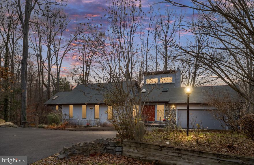 Experience easy, riverfront living in this spacious 5 bedroom, 3 bath contemporary/mid-century 
modern home nestled on a quiet cul-de-sac in desirable Occoquan Forest. With a little over 
4,000 sqft of living space, this rare and unique riverfront property offers incredible natural light 
with floor to ceiling windows and skylights, dramatic architecture and serene views of the 
Occoquan River. 
The dramatic two-story foyer with marble flooring leads you into the living room and out to an 
expansive, recently replaced, 2-tiered deck spanning 1,446 sq ft. Also, on the main level you 
find the primary bedroom large enough for a sitting area with a luxurious ensuite bath with 
marble throughout and walk in closet and two additional bedrooms.  
Upstairs relax in the loft in front of 1 of the 3 woodburning fireplaces with heatilators. The loft 
overlooks the tree tops and river making everyday feel like a vacation. 
The fully finished walkout basement is where you will find bedrooms 4 and 5 both with sliders 
that lead out to the deck along with a large rec room.  
Recent updates include professional interior paint throughout, an upstairs HVAC (2023), downstairs HVAC (2024), a generator that services the main part of the home, a new dishwasher and microwave.  
This unique property offers an incredible foundation with space, light and location, ready for your personal updates to make it your own. 
Optional membership in the Occoquan Forest Owners Association (OFOA) is available for just 
$265.00 per year and offers access to private river amenities including a boat ramp, community 
dock, canoe racks, tot lot, dog park, picnic pavilion, fire pit and walking trails. 
Minutes from commuter routes, shopping and parks. This unique waterfront property offers the 
perfect blend of space, privacy and endless potential.