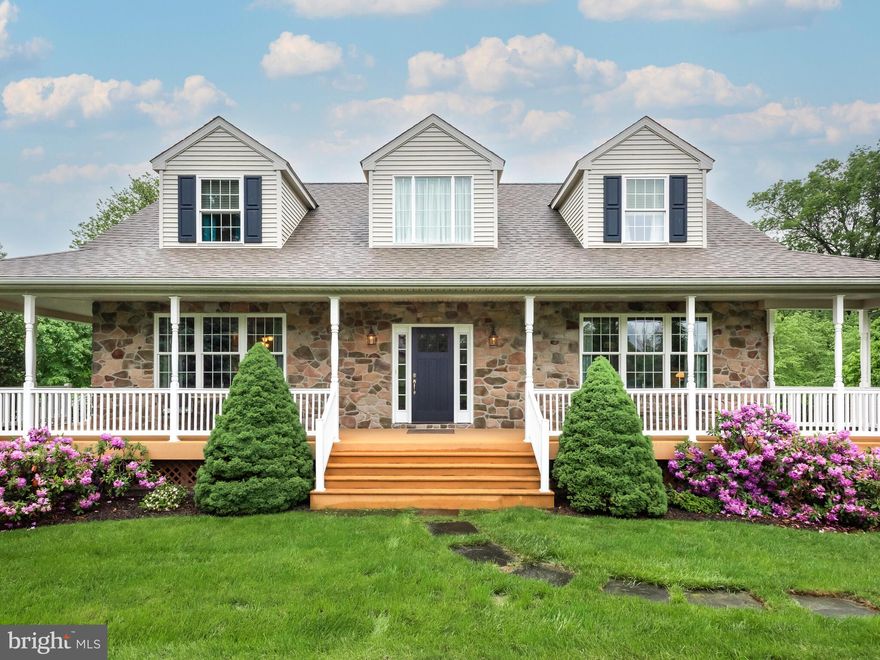 A rare opportunity to own a charming 4.9 acre property nestled in the heart of Chester Springs! Welcome to 1038 Bartlett Ln, a classic colonial home with wrap around porch to enjoy the serene settings. A wonderful place to live inside and out. The main living area is an open floor plan to the eat-in kitchen. Bright with cream colored cabinetry topped with elegant, glass front display cases lit from within and the warm glow of under cabinet lighting. Polished granite countertops, a center island with seating, and the huge pantry offer a comfortable and functional setting for meals and dining. The butler station with an additional sink, wine rack, and mini fridge is a great prep area for coffee or cocktails. Recessed lighting illuminates the interior and a wall of windows showcases the lush greenery of the wooded lot beyond. The living room is highlighted by the stone, gas fireplace with mantel and french doors leading to a fabulous deck. This elevated, composite deck has covered portions to soak in the splendid gardens and grounds in rain or shine. At the front entry, you'll be greeted by the sun-drenched, two story foyer and gleaming hardwood floors that stretch throughout the main floor. A large formal dining room sits off the kitchen and is the perfect place for holiday gatherings. From the foyer, an optional bedroom which is currently being used as an office space is a fantastic room for guests to overlook the 29 acre farm across the road. The nicely situated powder room completes the picture of the main level of this lovely property. Upstairs, double doors open into the main bedroom featuring a wall mounted fireplace for romantic and cozy evenings. A luxurious master bath awaits with a fully tiled walk-in shower, jetted tub, dual vanity, private water closet and linen closet. This generously sized room has a walk-in closet and provides plenty of space for furniture and storage. Across the hall, the two bedrooms are joined by a jack & jill bathroom with shower tub combo and double vanity. Off the hallway, a laundry room with stackable washer dryer and sink brings an added convenience to the upper level. The daylight walkout basement is the perfect flex space for entertaining, a home gym, or a potential in-law suite. This lower level has endless possibilities and features a bar area, full bathroom with shower stall, and wall mounted fireplace. The access to the attached two car garage sits at the base of the stairs. The outside spaces of this home are spectacular and peaceful. The fantastic grounds have been meticulously landscaped creating a true oasis. An outdoor shower is ideal for rinsing off after a day of gardening or taking advantage of the warm summer weather. Beautiful views, gorgeous hardwood floors, bathed in natural light, and a huge deck all come together to make 1038 Bartlett a very special place to call home.  This is it, Welcome Home!