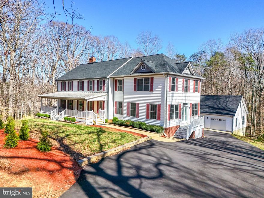 *OPEN HOUSE: 3/27 5-7pm, 3/29  1-3pm, 3/30 2-4pm***Welcome to this stunning custom-built home with over 4500 finished square feet of living space and just a stone’s throw from the Clifton/Fairfax County border. Nestled on three private acres, this spacious home provides a peaceful retreat while keeping you close to everything you need. The main level boasts a chef’s dream kitchen, featuring a large island, ample custom cabinetry, and fingerprint-resistant stainless steel appliances. The adjoining dining room offers a cozy fireplace and seamless access to a covered patio and deck—perfect for entertaining. Flanking the kitchen is an oversized recreation room, with a full bath and entertaining bar. This versatile space could also serve as an IN-LAW SUITE or MAIN LEVEL PRIMARY SUITE. The foyer leads to a living room with French doors with another fireplace, and an office space. 
Upstairs, the expansive primary suite is a true retreat, offering TWO walk-in closets and a spa-like ensuite. A second bedroom with an ensuite,  two additional spacious bedrooms,  another full bath, and LAUNDRY CENTER complete the upper level. The walk-out basement includes a media room, a partially finished rec room, and a large storage room.  Outside, you’ll love the welcoming front porch and a covered deck in the rear of the home...ideal for relaxing and taking in the serene surroundings. A detached three-bay garage provides ample parking and storage, with an additional heated and cooled studio, workshop, or office above—a perfect flex space for your needs! Outdoor enthusiast? The Bull Run marina is 2 miles away where you can launch kayaks or small boats, or enjoy a hike on the Occoquan Trail.  Nearby, the historic town of Clifton offers restaurants, shopping, and a winery. The VRE station is located just miles away making commuting a breeze. Downtown Manassas, which offers tons of shopping and dining options  Recent updates include: Roof (2024), Two renovated upper-level baths (2024), Driveway paved (2024). The Hunters Woods HOA includes trash and snow removal.  Other updates include: newer windows, HVAC, water heater, and  kitchen renovation.
This home truly offers the perfect combination of luxury, space, and tranquility—all within reach of major conveniences.