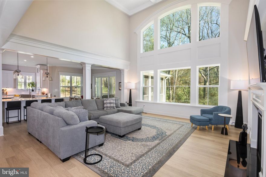 EXCITING NEW PRICE!!!
Elegance Abounds: A Custom Contemporary Oasis on lush 3+ Acres
Step into luxury with this magnificent 2024-built, 5BR, 5.5BA, 4-car garage dream home showcasing modern design and the finest conveniences. Nestled on over 3 acres of lush landscaped grounds, this stately 5,435 above grade sq ft brick and hardie siding showstopper boasts endless upgrades and thoughtful touches on a serene wooded lot. 

Upon entering, the grand FOYER welcomes with triple crown molding, a sparkling chandelier, and a sweeping staircase. 10' ceilings, oversized energy efficient windows, and high-end Mohawk waterproof Revwood flooring throughout the home add to the luxurious atmosphere. Off the foyer, French doors lead into a private OFFICE or library, with built-in shelves, generous windows, and detailed wood trim. Perfect for hosting, the formal DINING ROOM features tray ceilings, recessed lighting, two chandeliers, and built-in speakers. A circular hallway leads to the expansive FAMILY ROOM, where 20-foot coffered ceilings and a stunning Palladian window fill the space with light and a view of your private forest. A cozy gas fireplace, flanked by custom shelves, adds warmth and charm to the room.

A chef’s dream, the gourmet KITCHEN boasts a seamless suite of flush-mounted high-end Professional GE Café appliances including TWO SINKS, TWO DISHWASHERS, sleek cabinetry dual islands, undercounter beverage center, 48" range with wok burner and flat top griddle, quartz countertops and 4 ovens. Adjacent to the kitchen is a bright BREAKFAST ROOM and a charming screened-in PORCH that overlooks the property, complete with a second gas fireplace, high-end Trex flooring, panoramic views of the 3+ acres, and all the amenities for outdoor entertaining—including a 9 ft glass accordion door, propane hookups for additional heating during cooler months and wiring for outdoor speakers.

A separate BAR area with wine fridge and DUAL MUDROOM with built-in storage for shoes, jackets and gear offer ultimate convenience. An additional walk-in coat closet provides plenty of extra storage.  The home also boasts two separate two-car garages (four spaces in total), each with barn-style doors, openers, and ample space, electric car charging, including one garage with extra length to accommodate 2 larger vehicles. A GUEST SUITE with an adjacent full bath completes the first level.

Upstairs, luxury continues with 9-foot ceilings and an open landing with a balcony that overlooks the family room. The spacious PRIMARY SUITE is a private retreat, featuring French doors leading to both the bedroom and a separate sitting area. With a tray ceiling, recessed lighting, and abundant natural light, this suite offers a serene escape. The spa-like EN SUITE BATHROOM includes a massive double shower with dual rain heads, a soaking tub framed by windows, a double vanity, and a separate water closet. The expansive walk-in closet completes this luxurious space.

Three secondary bedrooms each offer en-suite baths, walk-in or double-door closets, and custom details like mosaic or ceramic tile flooring. The upstairs laundry room is equipped with top-of-the-line front-loading washer and dryer, and includes base and wall cabinets, quartz countertops, large SS sink and pull down faucet. 

Another 2,782 of unfinished SF walk-out basement with  9' ceilings, large windows and multiple glass doors awaits for a dream entertainer's haven with endless possibilities.   Insulated and partially framed, with a 100 amp basement sub panel,  it's ready for customization.

More highlights include full house generator wiring and hookup, architectural uplighting system, propane heating  system & hot water heater, a lawn irrigation system, and safe, clean well water from a 600 ft deep, high capacity,  12 gallon per minute well, filtered with UV, carbon iron, and charcoal systems.