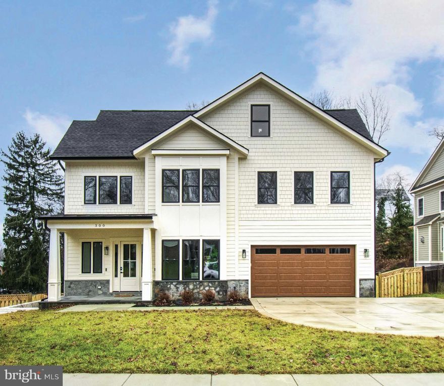 Welcome to 300 John Marshall Drive NE, a stunning, custom blend of modern luxury and thoughtful design in the Town of Vienna. This newly constructed home offers over 6,500 square feet of wonderful living space, featuring seven bedrooms, seven full en-suite baths, and two half baths. Every detail of this residence meticulously creates an atmosphere of elegance, comfort, and functionality.

The exterior boasts a timeless Craftsman-style architecture enhanced by modern design elements. The unique stone front elevation and fiber cement lap siding provide durability and beauty. A welcoming covered portico with a decorative headboard ceiling leads to precast concrete entry steps, while the professionally landscaped yard and a lush lawn enhance curb appeal, with a fully fenced yard. The home's concrete driveway and lead-walk, low-maintenance metal railings, and architectural roof shingles with standing seam metal accents ensure both style and longevity.

Step inside to discover soaring 10-foot ceilings on the main level, complemented by wide-plank engineered hardwood floors and an open-concept layout. The gourmet kitchen is a chef's dream, featuring custom soft-close cabinets, commercial-grade stainless steel appliances, stunning quartz countertops, and a spacious island ideal for cooking and entertaining. This space flows seamlessly into the family room, where a gas fireplace adds warmth and charm. Adjacent to the kitchen, the formal dining room offers an elegant meal setting connected to a convenient butler's pantry and full pantry. A covered terrace extends the living space outdoors, providing serene views and effortless indoor-outdoor living.

The upper level is a retreat anchored by the luxurious owner's suite. This sanctuary features two walk-in closets and an indulgent bathroom with double vanity, soaking tub, heated floors, a glass-enclosed shower, and designer fixtures. This level includes three additional bedrooms with private en-suite bathrooms, offering ample space and privacy for family or guests. A conveniently located laundry room adds practicality to this level. Ascend to the loft level and discover a versatile space that includes separate living space and an additional bedroom with a full bath. This area is ideal for accommodating guests, creating a private home office, or establishing a tranquil retreat within the home.

The lower level expands your living possibilities with a sprawling recreational room, a bonus room with a half bath, and another private bedroom with an en-suite bathroom. Whether you envision a home theater, gym, or game room, this space provides endless personalization opportunities. 

Luxury touches abound throughout the home, including wide-plank hardwood floors on the main and upper levels, tray ceilings, and designer lighting. Comfort-height vanities, elongated toilets, and porcelain tile complete the bathrooms' sophisticated and functional design. Energy-efficient recessed LED lighting and high-end Delta and Kraus fixtures complete the refined interiors.

Situated in one of Vienna's most desirable neighborhoods, this home offers convenient access to boutique shopping, fine dining, the recreational parks of the Town of Vienna and the W&OD Trail. Its location combines small-town charm with proximity to major commuter routes, making it the perfect choice for modern living. 300 John Marshall Drive NE is more than just a house - it's a masterpiece that offers a lifestyle of unparalleled luxury and comfort. Don't miss your chance to make this exceptional property your forever home.