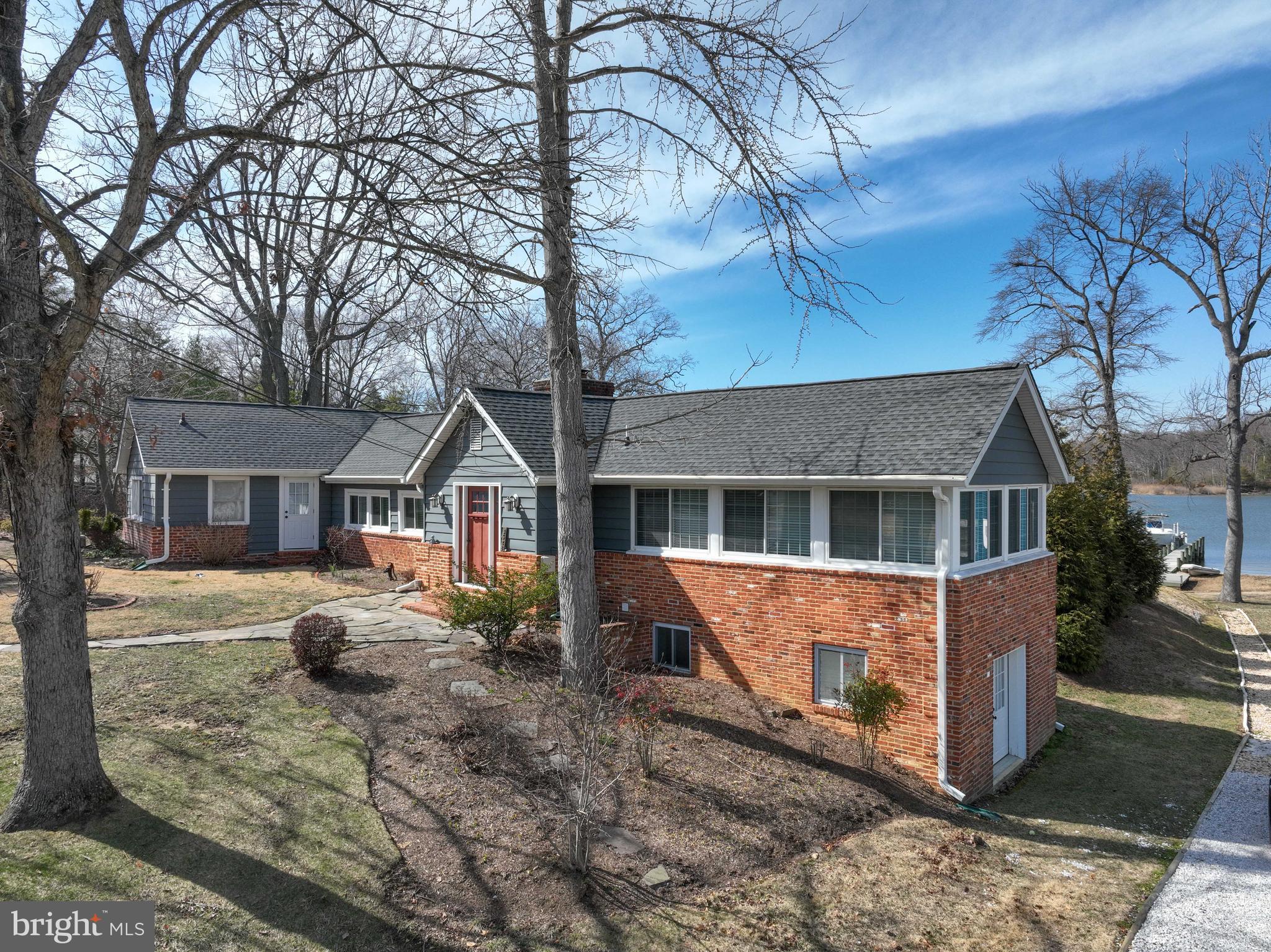 Don't miss this rare opportunity to own a charming waterfront retreat in the sought-after Loch Haven community! Boasting breathtaking views of the South River, this home is a true gem, complete with a brand-new pier featuring a 12,000 lb. remote-controlled boat lift. Enjoy full riparian rights, a unique benefit grandfathered in from the property's original sale in the 1950s. From the moment you step inside, you'll be captivated by expansive water views. The spacious family room is a showstopper, featuring wide-plank flooring, vaulted beamed ceilings, and a cozy fireplace, all framed by walls of glass that bring the outside in.
The kitchen includes a new stove and refrigerator, along with ample cabinet space and granite countertops. Just off the kitchen, the patio offers the perfect space for outdoor entertaining while soaking in the serene waterfront setting. The adjacent dining room is equally impressive with vaulted ceilings, wood beams, abundant natural light from the windows that surround the space, and hardwood floors. The main-level primary suite is a peaceful retreat with a luxurious newly renovated bathroom, a walk-in closet, and a large window designed to maximize the view. Two additional bedrooms and another full bath complete this level.
The fully finished walk-out lower level has been professionally waterproofed and offers a spacious recreation room, plus a utility room with workshop space.The exterior of the home is in the process of being updated with brand-new siding—photos of the planned enhancements are included in the listing photos. Located in the amenity-rich Loch Haven community, residents enjoy access to a private marina, boat ramp, sandy beach, tennis, pickleball, and basketball courts, as well as the scenic Farm Park. Conveniently located near Annapolis, Baltimore, and Washington D.C., this home is perfect for year-round living or an exceptional weekend escape. Schedule your private showing today and make this waterfront dream home yours!