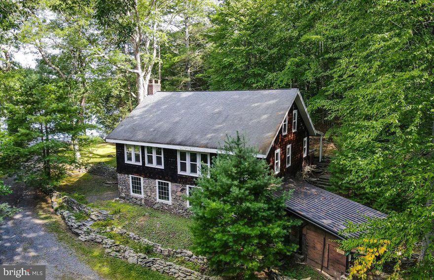 Welcome to Analomink Rod and Gun Club, AKA Analomink Lake!  Flat, wooded lot with gorgeous lake views from the homes expansive windows.  Private, Pennsylvania blue stone patio approximately 25 x 16 with built-in stone serving table and openings for grill placement.  30 x 8 Covered side porch.  Massive character filled, two story great room.  A perfect dining/living/entertaining space with spectacular fireplace.  Original heart-pine flooring throughout second floor.  Full basement (with newer windows, garage door, and double door entrance) that can be finished for huge added living space or more bedrooms!  Hydro therapeutic water purifier and Regal oil furnace replaced approximately 5 years ago.  10 x 7 shed, Fresh coat of paint on the interior of home.   Located in the desired Strousburg  School District!!  10 - 15 minute drive to downtown Stroudsburg and East Stroudsburg as well as Pocono Hospital.  Less than an hour to Lehigh Valley Airport and about 1.5 hours to Newark Airport.

The many amenities of the Lake include Walk right to the community Swimming Dock, Fishing, Boating, Shooting Range, Hiking, Picnic Area, Open Meadow, Nature at its best!  Bring your own Paddle board, Canoe, Paddle Boat.  Please call for more club and membership details.