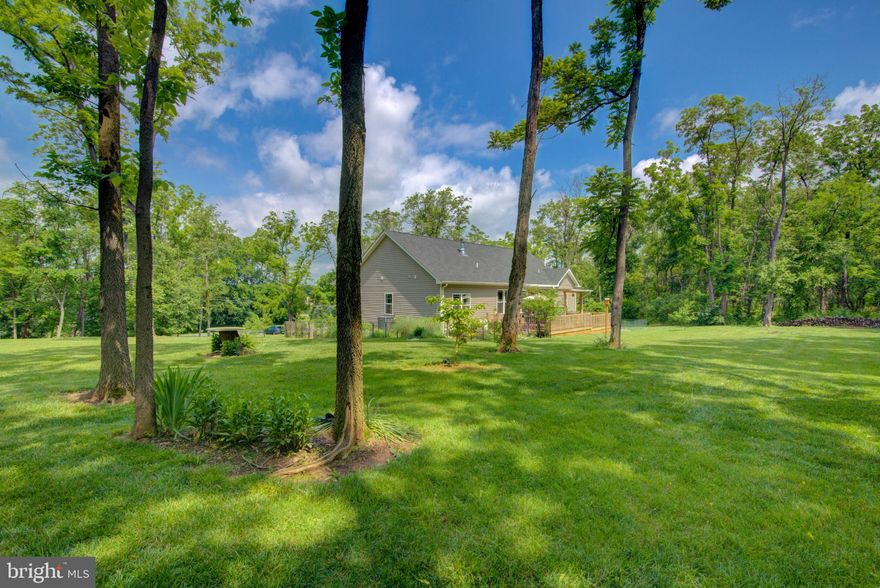 Just Listed!! Meticulously maintained 2020 Modern Contemporary 4 bed 3 bath 2 car garage rancher offers open floor plan in country location with no HOA on 1.65 acres! Over 2000 finished square feet featuring fully equipped kitchen outfitted with granite countertops, stainless steel appliance, gas cooking, subway tile backsplash, and pantry overlooking living/dining room combination w/ vaulted ceilings and wood burning fireplace. Built by Meta-Builders, LLC, this desirable split bedroom floorplan with the master bedroom suite offering dual closets, bathroom suite w/ subway tile shower and double vanity sinks and Junior suite w/ full bathroom, and two additional bedrooms w/ another full bathroom is the perfect layout. The entire house is outfitted with durable LVP flooring and tile in all baths, along with a full unfinished walkup basement with rough-in for future bathroom. Laundry on the main level with Maytag full size washer and dryer, custom cabinets, and wash basin. 2 car side load garage w/ opener. Walk out French doors to great outdoor entertaining space with a large composite deck with solar lights, partially covered with ceiling fan where you can enjoy 1.64 acres beautifully landscaped with trees, shrubs, and perennial flowers. There is even a cleared firepit/camping area in the rear of the property. Crate Myrtle lined paved driveway with plenty of parking! Subpanel in the basement ready for waiting for your outdoor hot tub. Situated off county road on 1.65 wooded acres. Less than 10 minutes from VA state line and downtown Charles Town, West Virginia. This is a must see to appreciate!