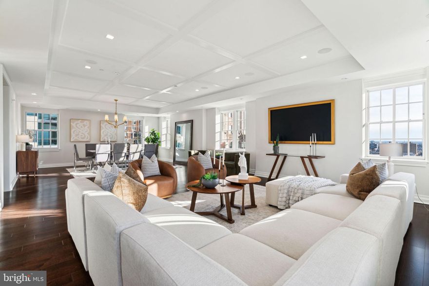 Stunning custom-built full floor residence with luxurious finishes, panoramic city views, and a balcony at The Lanesborough in Center City. This contemporary home includes 4 bedrooms (or 3 plus a private home office), 3.5 bathrooms, Mercier hardwood floors with herringbone inlay, and a plethora of custom appointments and high-end systems. Enter off of the building's secure, fobbed elevator into the custom vestibule with dramatic French doors. Past the entry is the grand center gallery which runs the length of the home. There is a powder room on one side of the hall and laundry closet with LG front load washer and dryer on the other. The private balcony showcasing spectacular city views is also located here. At the end of the center gallery past the bedrooms and office is the open great room with living/dining area and kitchen. An ideal space for both living and entertaining! The expansive living/dining room features 8 windows for ample natural light, a decorative reflective ceiling, and a surround sound entertainment system. The open chef’s kitchen features custom Honeybrook cabinetry, Taj Mahal quartzite kitchen counters, and a state of the industry appliance package which includes Miele built-in refrigerator/freezer, Miele professional gas range, Bosch fully integrated dishwasher, Marvel wine & beverage center, Dacor fully integrated wine dispenser & preservation system,  Miele built-in coffee center, and Marvel integrated refrigerator drawers. All of the bedrooms feature walk-in designer inspired closets and full ensuite bathrooms. The spacious primary suite boasts large windows, a wood paneled wall feature, and a large, built-out walk-in closet with shelving and drawers. The gorgeous primary bathroom includes two separate vanities, built-in linen storage, large soaking tub, and an Italian marble oversized walk-in shower with frameless glass entry and accent lighting. Across from the primary bedroom is the home office with French doors and built-ins that can be used as a fourth bedroom. Additional home details include an automated window shade system, an automated lighting system, an “ahead of the curve” computer network, and a music system that includes architectural speakers installed throughout the home that are easily controlled via smart device app. The Lanesborough offers residents the highest level of finish in each space. This elegant boutique building is one of a kind and is sure to please the most discerning purchaser of a Center City high-rise home. Residents enjoy a twenty-four hour doorman and concierge and state-of-the-art fitness center. One 10' x 12' storage unit located in the basement of the building is included.