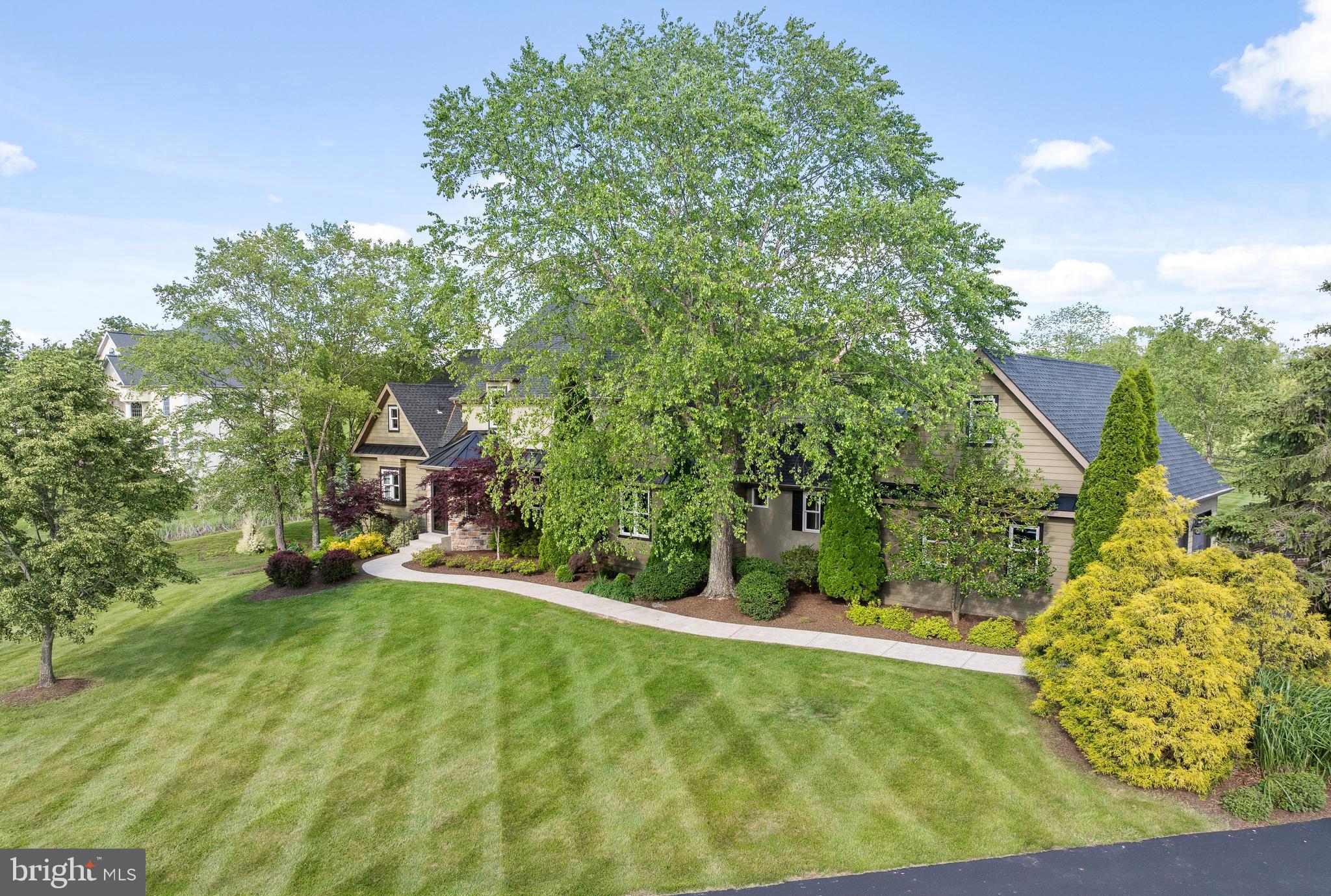 Enjoying the outdoor living space, surrounded by loved ones, you know you made the right decision…. This custom home provides ample room to spread out and gathering spaces for todays lifestyle. Over 2 acres of land offers the privacy you are seeking. With a first floor primary suite this home offers a versatile floor plan brimming with quality finishes, detailed millwork, and custom built-ins. The home has been updated, upgraded and loved by the current owners. Newer roof and newer HVAC systems (2022) means no worries for years to come. Enjoy the outdoor living space, thoughtfully designed for entertaining and gathering. The foyer opens to a graceful hallway with access to the staircase and a clear path to the expansive patio. Two sets of doors lead to the expansive exterior entertaining area. Large covered area with open beams and huge countertops provide everything needed for throwing a great party!! Grills, burner, sink, large built in cooler, TV and lots of seating!!! You will be ready for game day or for any other occasion that suits. The custom outdoor fireplace will extend the outdoor time into the fall as you relax with loved ones around the flames. The kitchen, featuring a large central island, granite countertops, a propane cooktop, and ample cabinet space. Breakfast room with cathedral ceilings, a back staircase, and access to the rear patio. The main-floor primary suite features cathedral ceilings, a large custom walk-in closet, full bath with heated tile floors, access to a private patio area and provides the peaceful sanctuary to recharge. The oversized 3-car side-entry garage offers ample space for parking and stairs access the storage area above. Upstairs, you’ll find four generously sized bedrooms and 2 full baths. Three of the bedrooms feature vaulted ceilings. The finished basement is perfect for entertaining, offering a theater area, a game area suitable for a pool table, a gym/workout area, a full bath, and a walk-out to a patio area. There's also a large storage/utility room. The home contains over 5,000 sq feet of finished living area and the comfort and livability is second to none. See this amazing custom home today!!