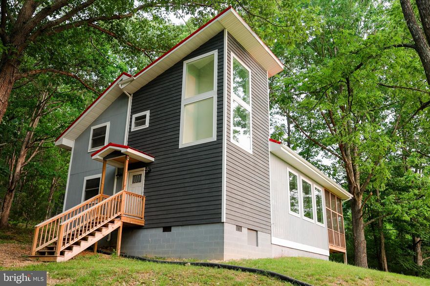 Stunning and Fully Furnished 4BD/2.5BA Home on 5.01 Acres in Lost River, boasting breathtaking mountain views. This recently renovated property offers a modern aesthetic with luxurious finishes, exquisite lighting, and upscale hardware. Move-in ready, it's perfect for full-time living, weekend getaways, or hosting family and friends. The architectural renovation includes a thoughtfully designed addition that houses the staircase, foyer, and additional storage, creating an open and spacious living area.
Stay connected with high-speed fiber optic internet, making teleworking a breeze and ensuring you can enjoy all your favorite streaming services. The property's versatility shines through, as it has been utilized both as a cherished weekend residence and a successful Airbnb.
Step inside to discover the interior amenities that will captivate you. The open living and dining space features vaulted ceilings, beautiful wood floors, and a charming stone fireplace. The updated kitchen boasts stainless steel appliances, a generous marble dining island with ample storage, and large windows that flood the space with natural light and provide stunning views of the back deck.
Indulge in luxury in the updated bathrooms, complete with heated tile flooring, marble vanity countertops, double vanity sinks, and a relaxing soaking tub in the primary bathroom. The walk-in showers feature tempered glass doors, adding a touch of elegance.
Outdoor living is a delight with a screened porch and a sun deck, expanding the available space for relaxation and outdoor activities. Keep your yard tidy with the convenient 10x12 storage shed. The front yard's gentle slope makes it a perfect spot for winter sledding adventures.
This exceptional property is conveniently located just minutes away from Trout Pond National Recreation Area, offering opportunities for swimming, hiking, fishing, and camping. Lost River State Park is also nearby, featuring additional hiking trails, a spring-fed swimming pool, cabins, pavilions, and more. Commuting from the DMV area is a breeze, as it's only a two-hour drive. Enjoy the charm of the Lost River Valley and explore the delightful dining and shopping options in Lost River,  and nearby towns of Wardensville and Mathias.
Experience the pinnacle of comfort, style, and natural beauty in this remarkable Lost River home. Don't miss the opportunity to make it yours!  CLICK ON LINK TO SEE 360 TOUR.