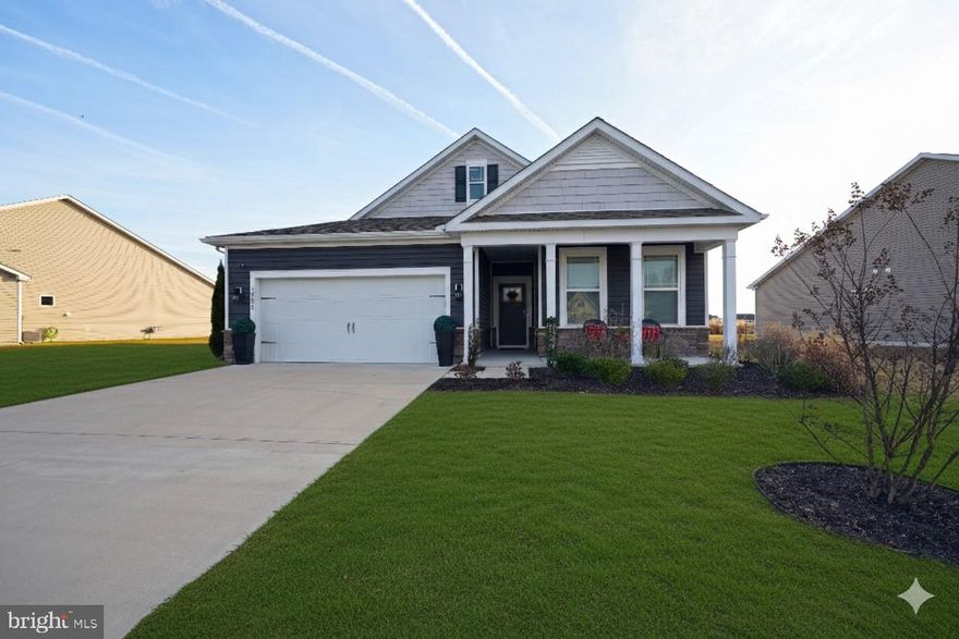 Move in ready and pristine condition. Pond front single floor rancher built in 2022 and  on a half acre lot.  
Offering a coastal design with a lot of natural sunlight. LVP flooring, carpeted bedrooms and window treatments. A large front porch with an easterly exposure and morning sunrise. The rear covered porch offers amazing evening sunsets overlooking the large community pond. Enter into the large foyer and the house opens into a large open floor plan.  White, bright and airy. The amazing gourmet kitchen features stainless steel appliances and a large center island. Perfect for entertaining with a large dining area and living room. The kitchen features 42” white cabinetry, glass tile backsplash, and granite countertops.  
The primary suite  features a spa like ensuite with a dual vanity,  stall shower, a private water closet, and a massive walk-in closet to accommodate any wardrobe. Two additional guest bedrooms share a well-appointed hall bath, a spacious laundry room, and interior garage access complete this home. Stonewater Creek offers  amenities that include an outdoor pool, tennis and pickleball courts, a playground, a dog park, a clubhouse, and a fitness center.  Close proximity to Long Neck, In Town Millsboro, In Town Georgetown, In Town Lewes and the Boardwalk of Rehoboth Beach. Furnishings could be purchased as part of the ratified contract. Motivated seller makes this a must see property!