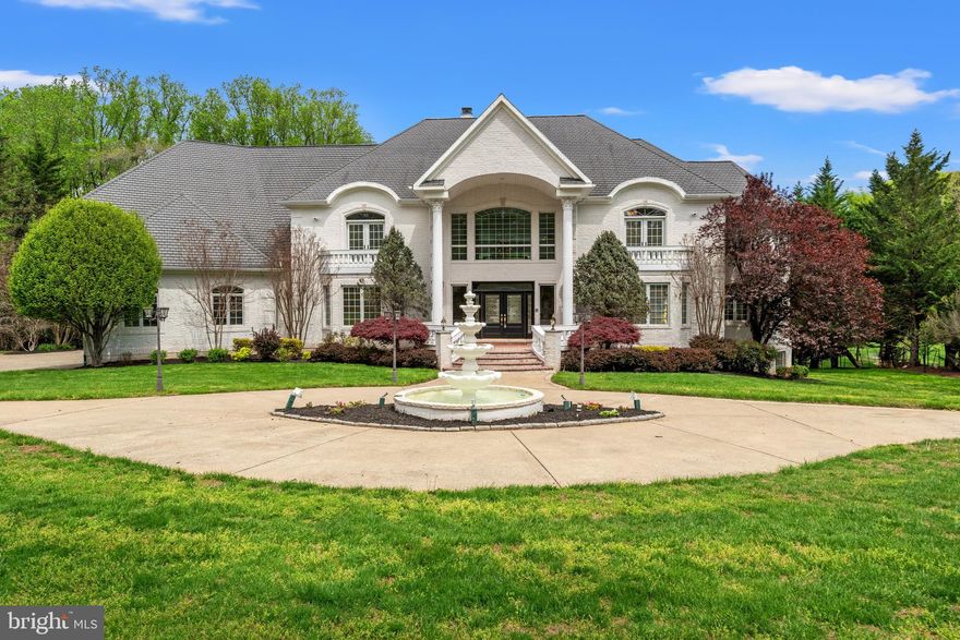 Extraordinary, luxury estate on two beautiful acres offering the best in Potomac lifestyle!  With a welcoming 4-tiered, front fountain, dramatic 2-story entry foyer with dual staircases, 6 bedrooms, 6 full bathrooms, 4 half bathrooms, a 4-car garage, elevator, gracious private and public spaces and an indoor pool, this fabulous property provides the best in family living and formal entertaining, all within two minutes of the shopping and restaurants of Potomac Village and Great Falls Park, with it's access to the C&O Canal, perfect for walking and biking adjacent to the magnificent Potomac River.  This home, built in 2002, has meticulous craftmanship and wonderful amenities throughout, from the gleaming wood floors, arched doorways, built-ins, custom moldings and walk-in cedar closet to its move-in condition and functional floor plan.  The main level includes formal living and dining rooms, a sunroom, library, 2-story family room with 2-sided, gas fireplace adjacent to the gourmet kitchen with granite island and breakfast room and level access to the spacious garage.  The upper level features the primary bedroom suite, complete with a balcony, sitting area, two walk-in closets, and a luxurious primary bathroom with Jacuzzi-style tub and shower stall. The upper level also includes a spacious upper level family room and three additional bedrooms, one with an en-suite bathroom and balcony and two with a connecting bath. The walkout lower level is an entertainer's dream, featuring a full kitchen/bar area, two guest or in-law suites, and an exercise room/dance studio.  The deck off of the main level with gazebo has amazing views of the expansive grounds backing to woods, and the indoor pool with automatic cover and balcony with entertaining space offers year-round swimming!  This house is ready to sell at this very attractive price!